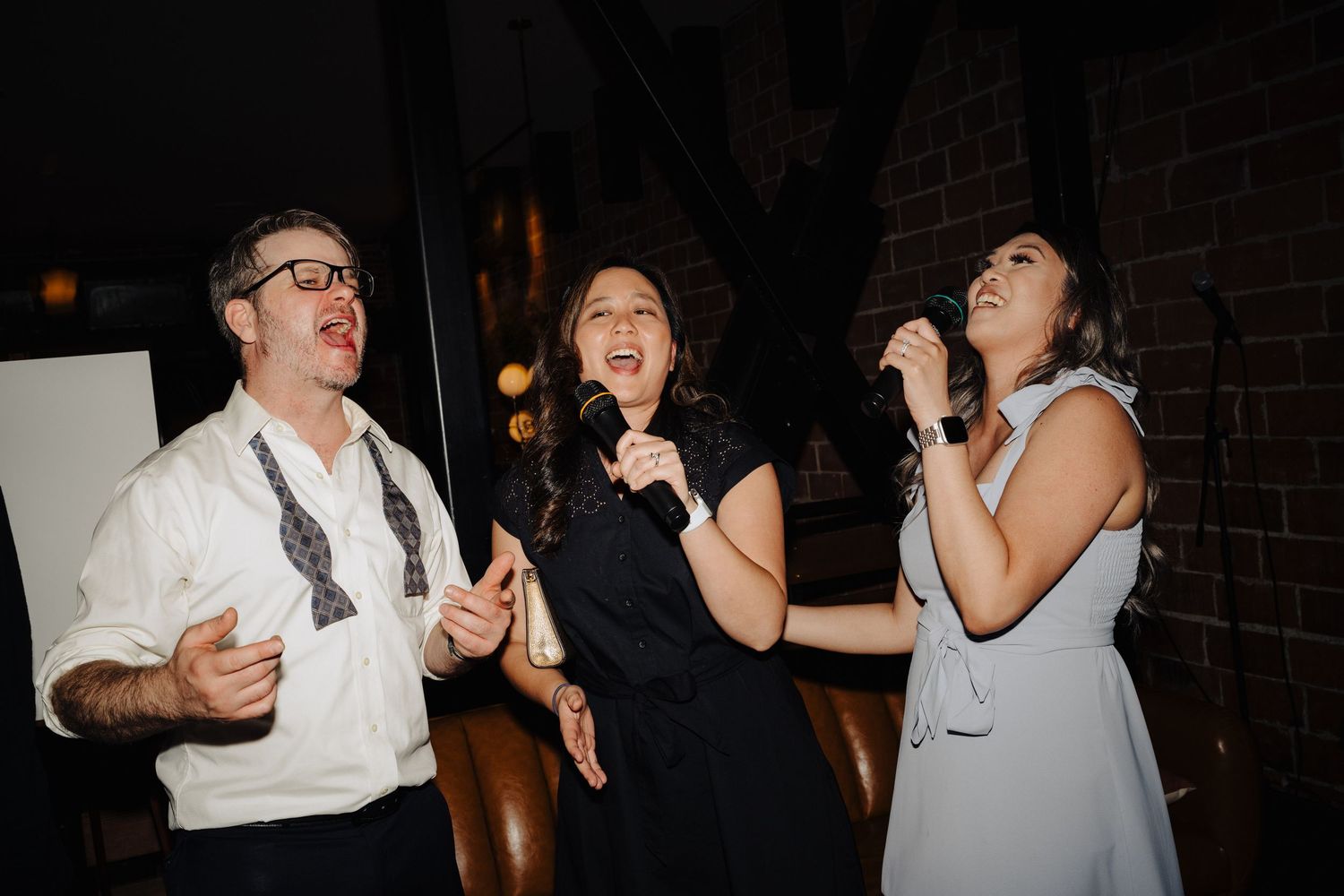 Wedding guests enjoying themselves while dancing at reception.