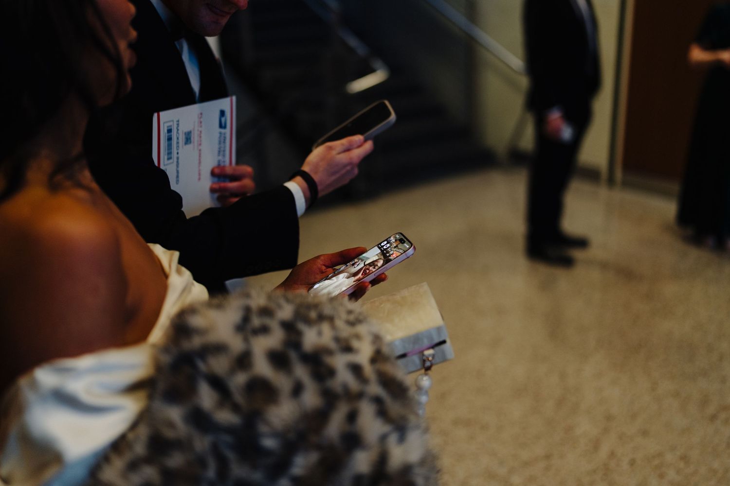 Close-up of hands holding documents during what appears to be a signing ceremony.