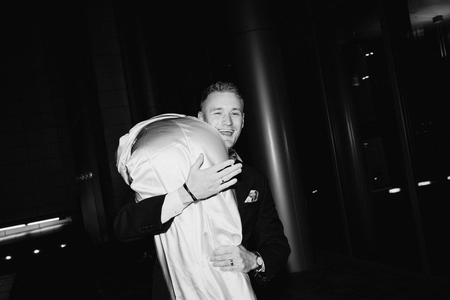 A joyful black and white candid moment captured during an evening celebration.