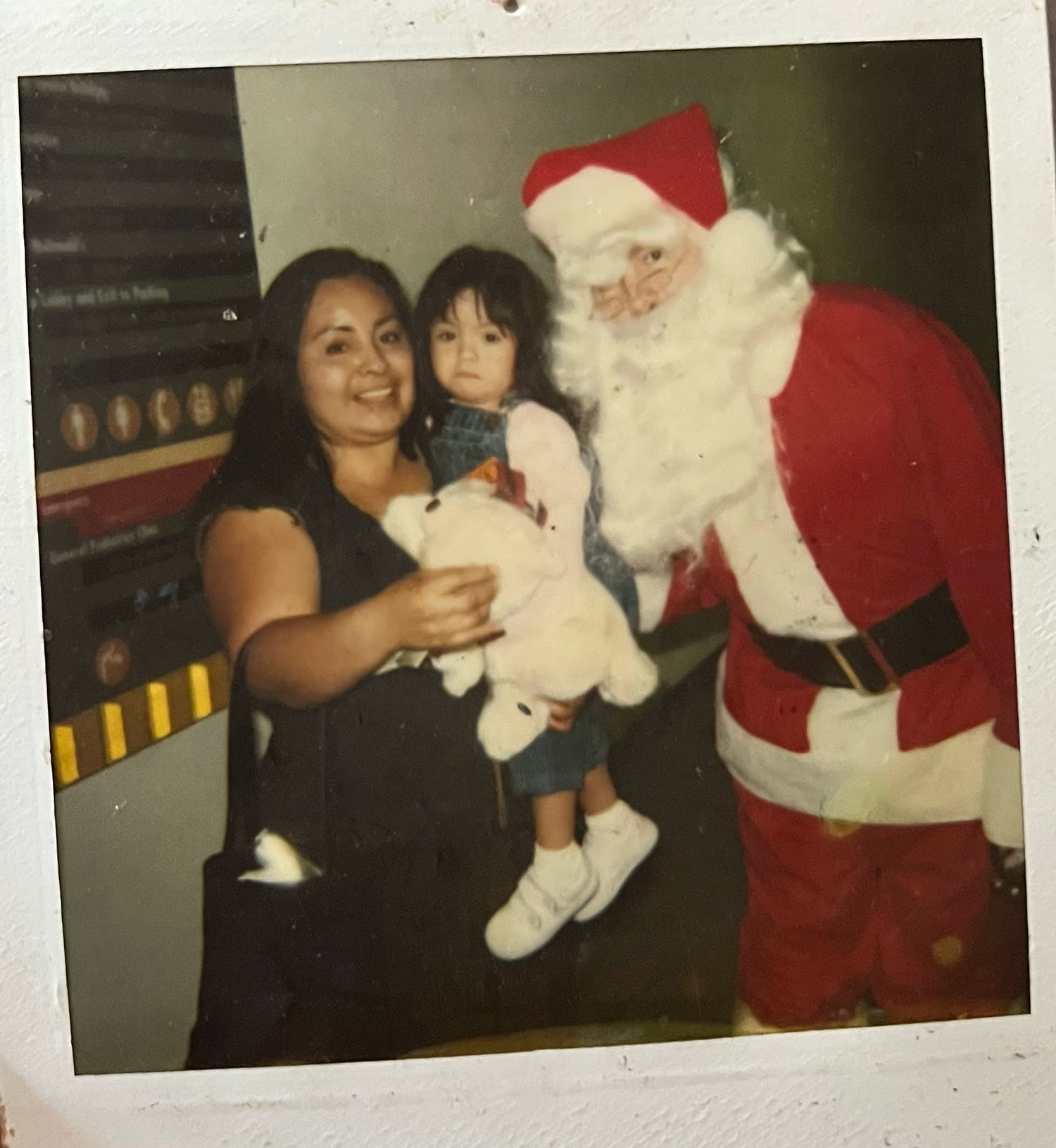 A vintage holiday photo shows a meeting with Santa Claus at what appears to be a mall or department store.