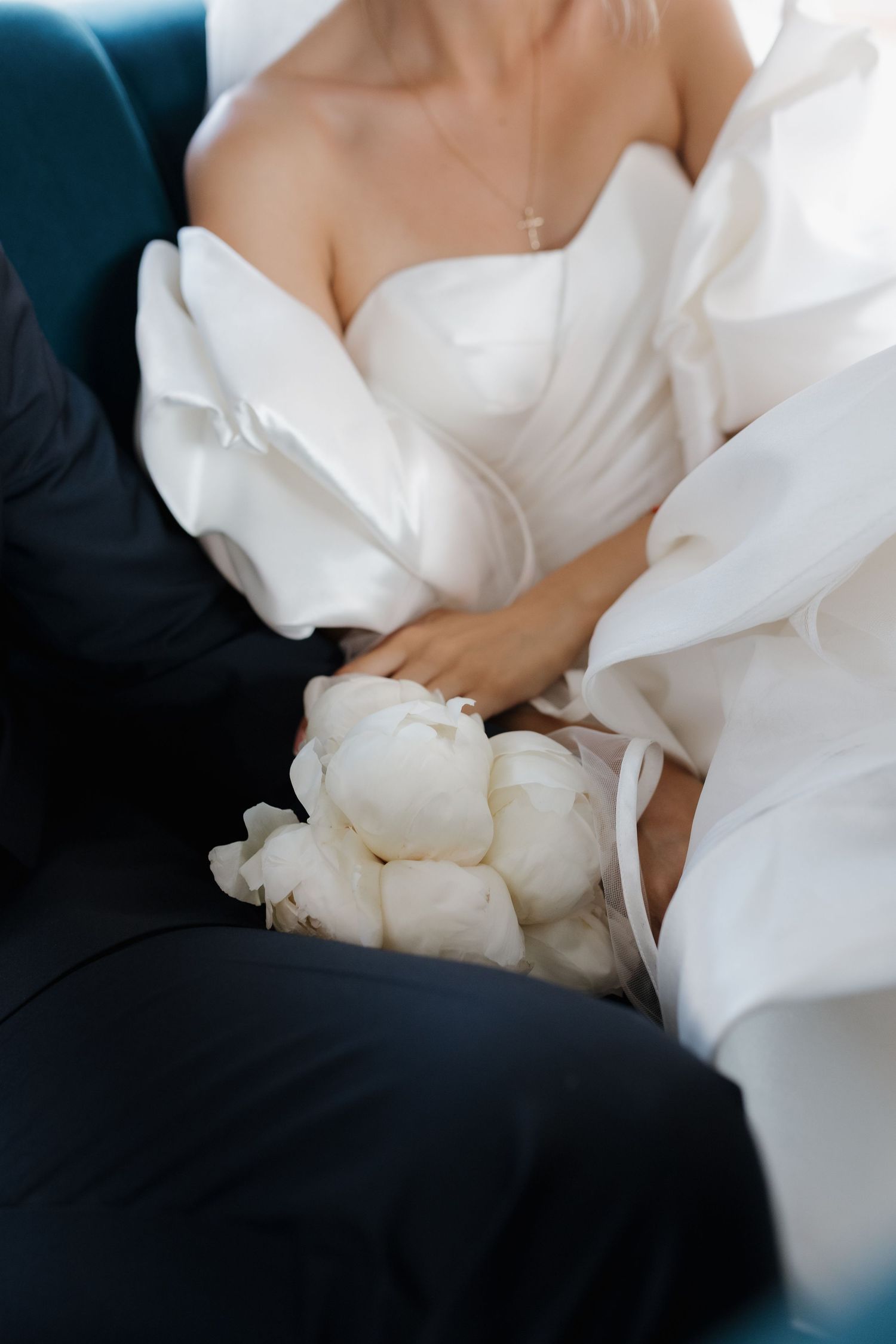 White bridal gown fabric details shown in a series of artistic close-up shots highlighting the dress's elegant texture.