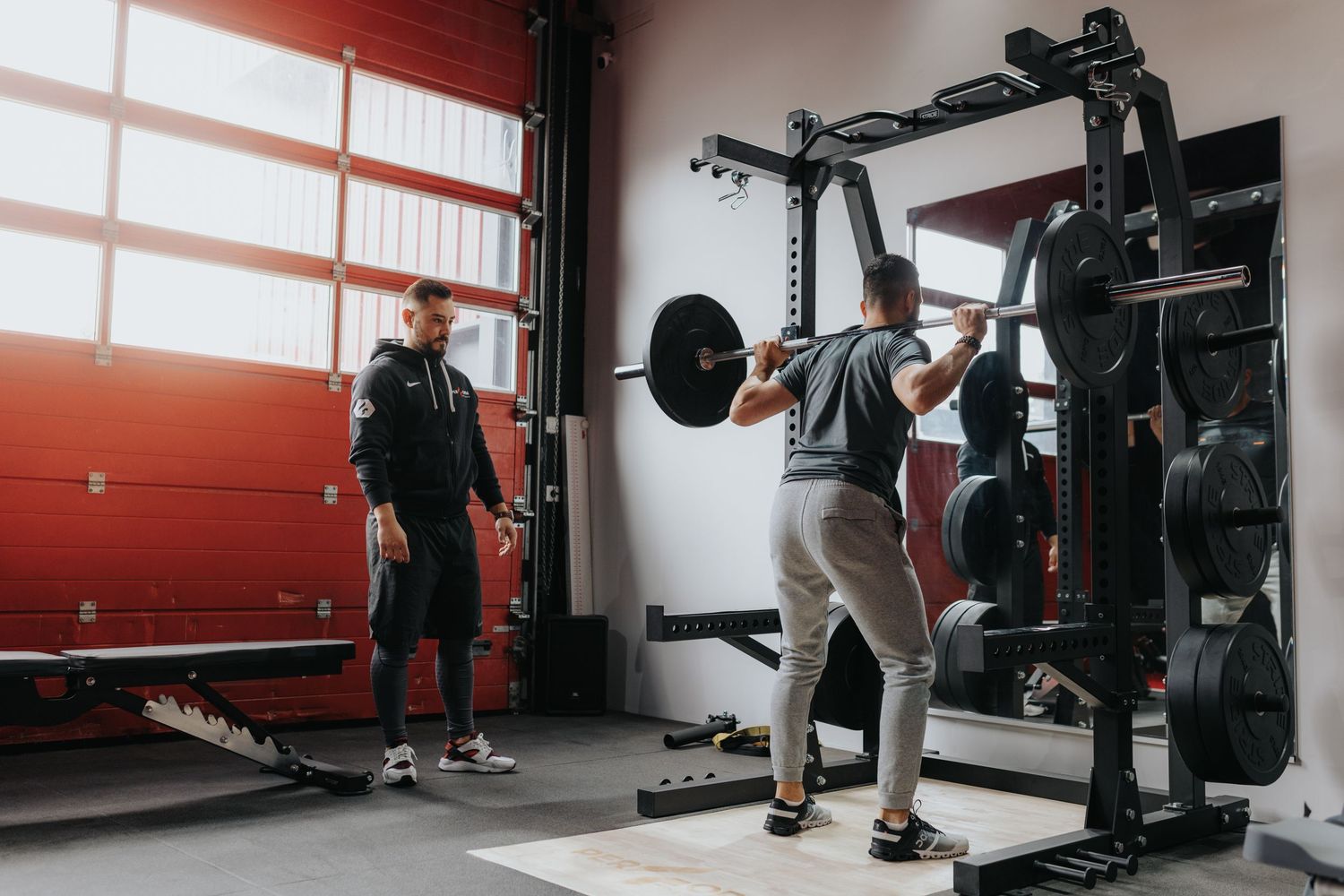 Five sequential gym shots showing people working out with exercise equipment and trainers in a modern fitness facility.