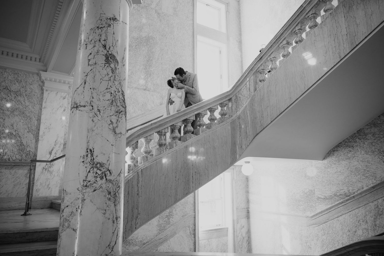 Construction workers carrying out interior demolition work in a building with exposed walls and debris.