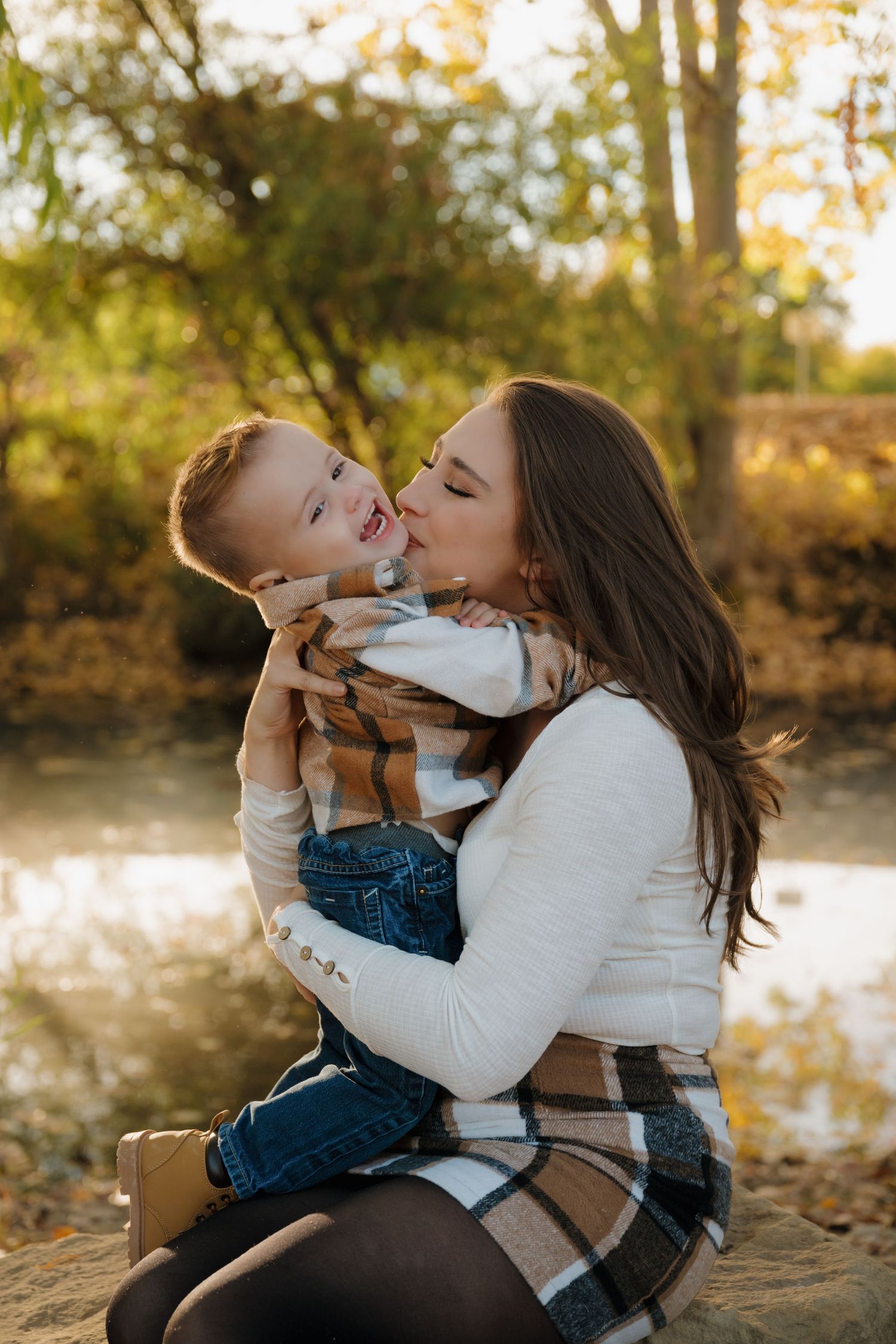 An autumn portrait filled with warmth and affection beside a tranquil pond.