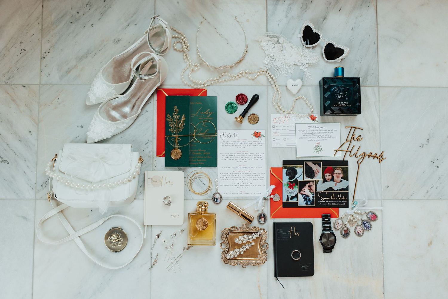 Wedding day details flatlay with invitations, rings, perfume and accessories on marble background.
