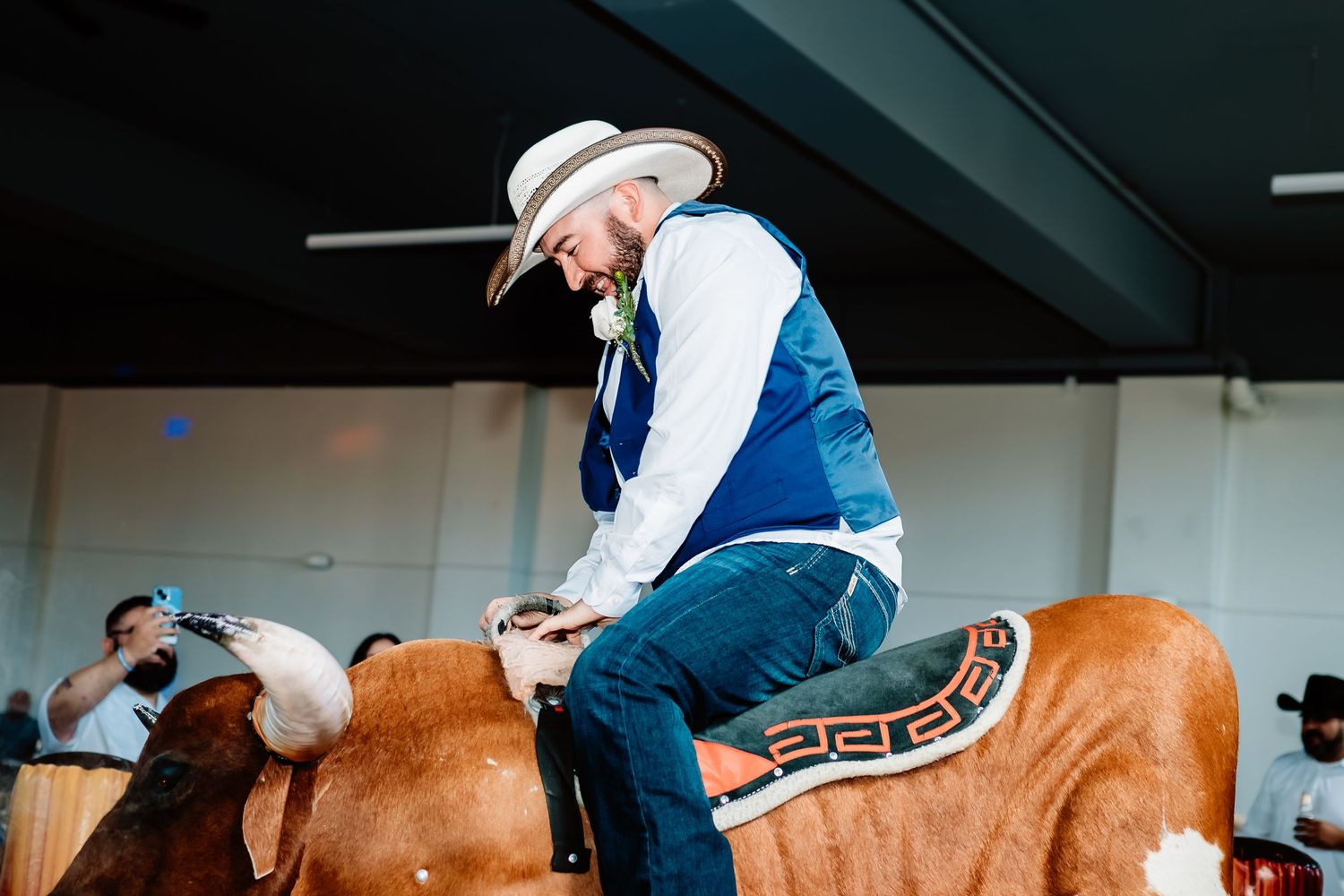 A rodeo rider skillfully attempts to stay mounted on a bucking bronco during a professional competition event.