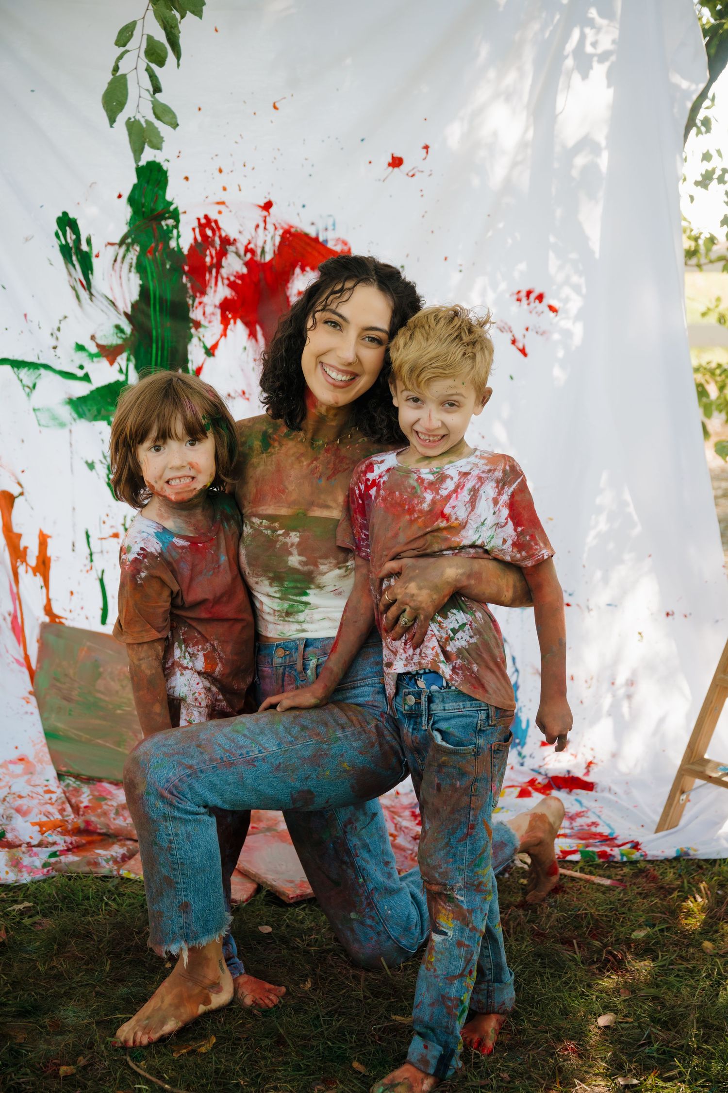 A joyful paint-splattered scene with bright red and green splatters on a white backdrop.