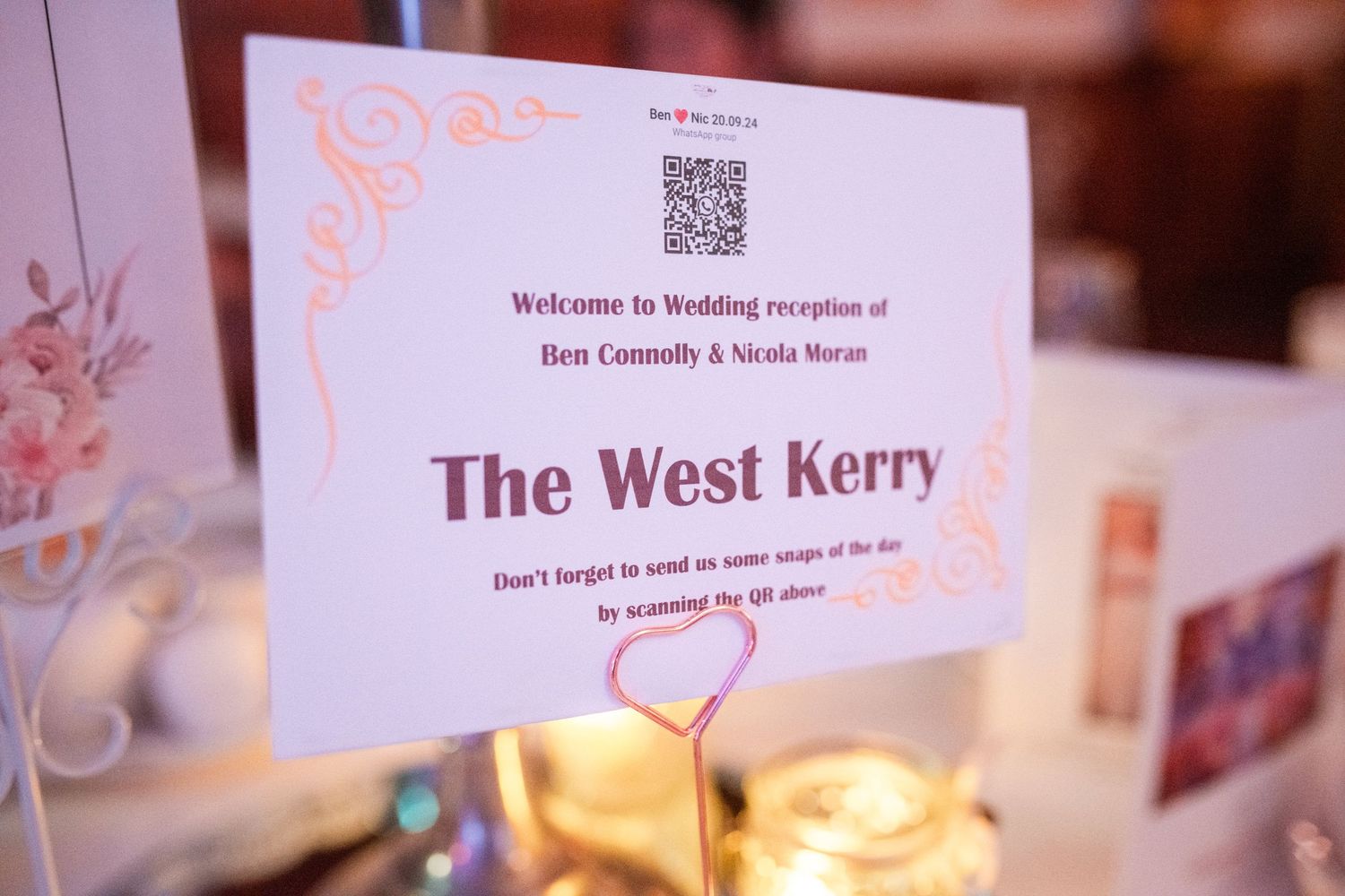 Wedding reception seating cards with QR codes laid out on a table.