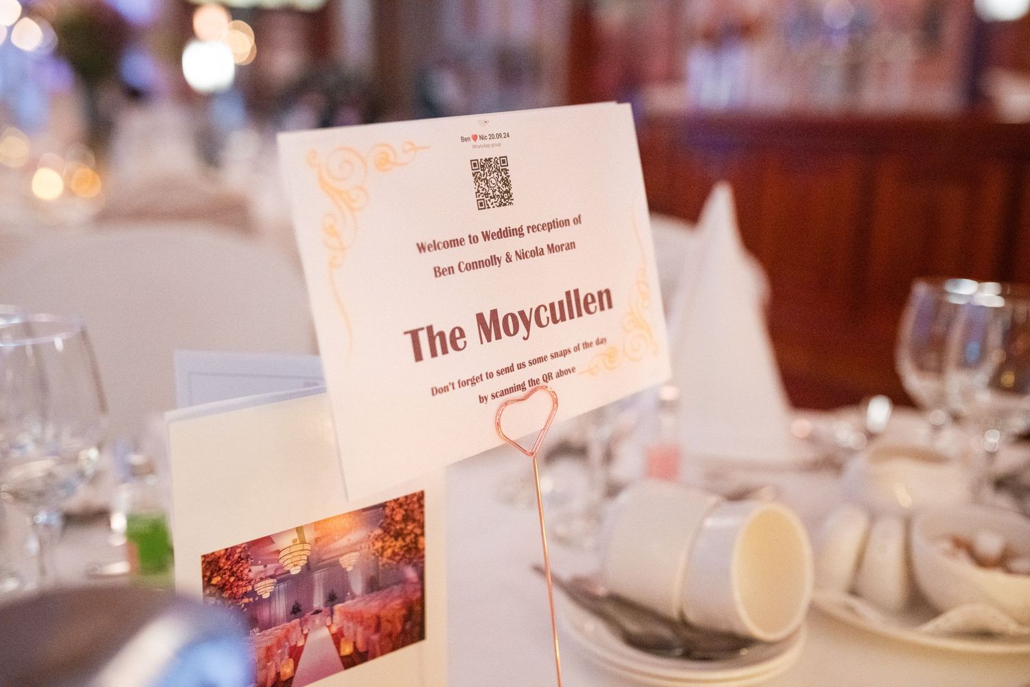 Wedding reception table setting with name card reading 'The Moycallen' in elegant typography.