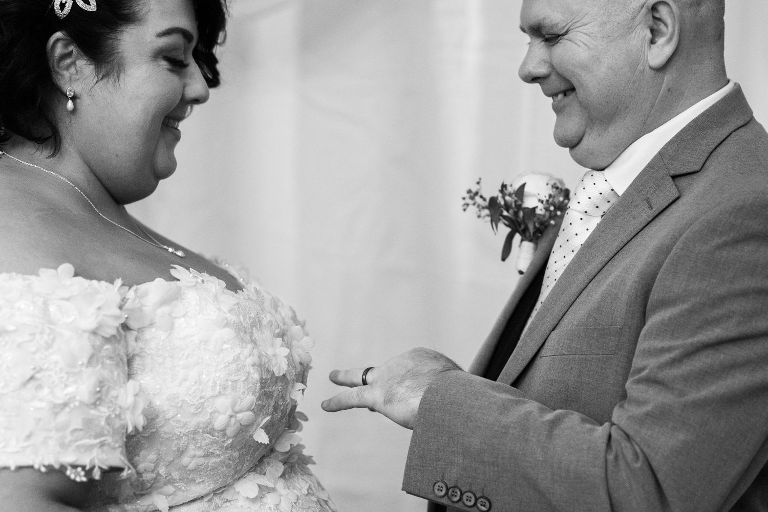 A happy couple shares a joyful moment during their wedding ceremony as they exchange rings.