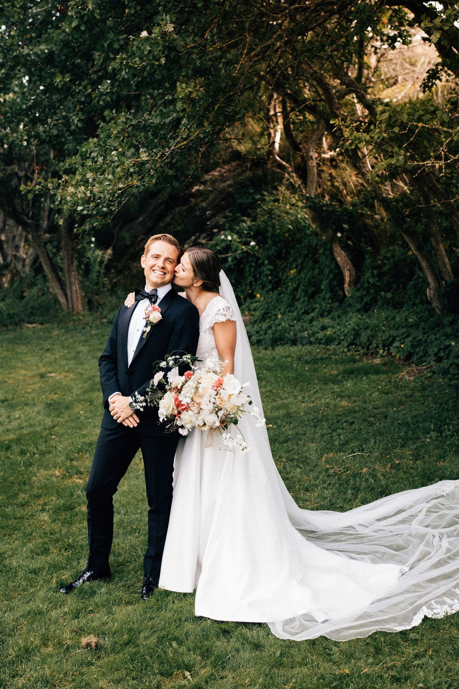 Romantic outdoor wedding sequence showing couple in formal attire with flowing white dress against lush garden backdrop.