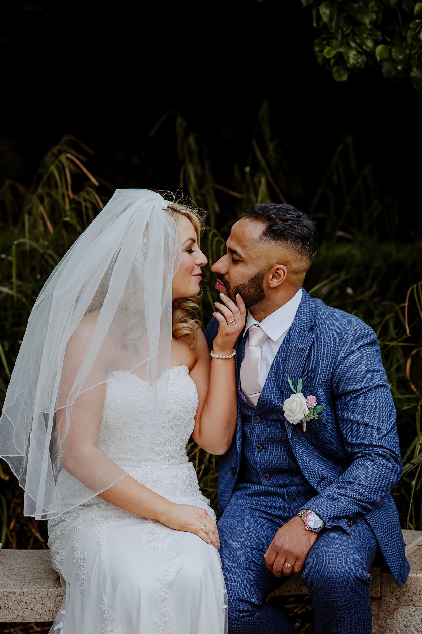A newlywed couple shares an intimate and romantic moment on their wedding day in the Shamrock Lodge Hotel garden, Athlone.