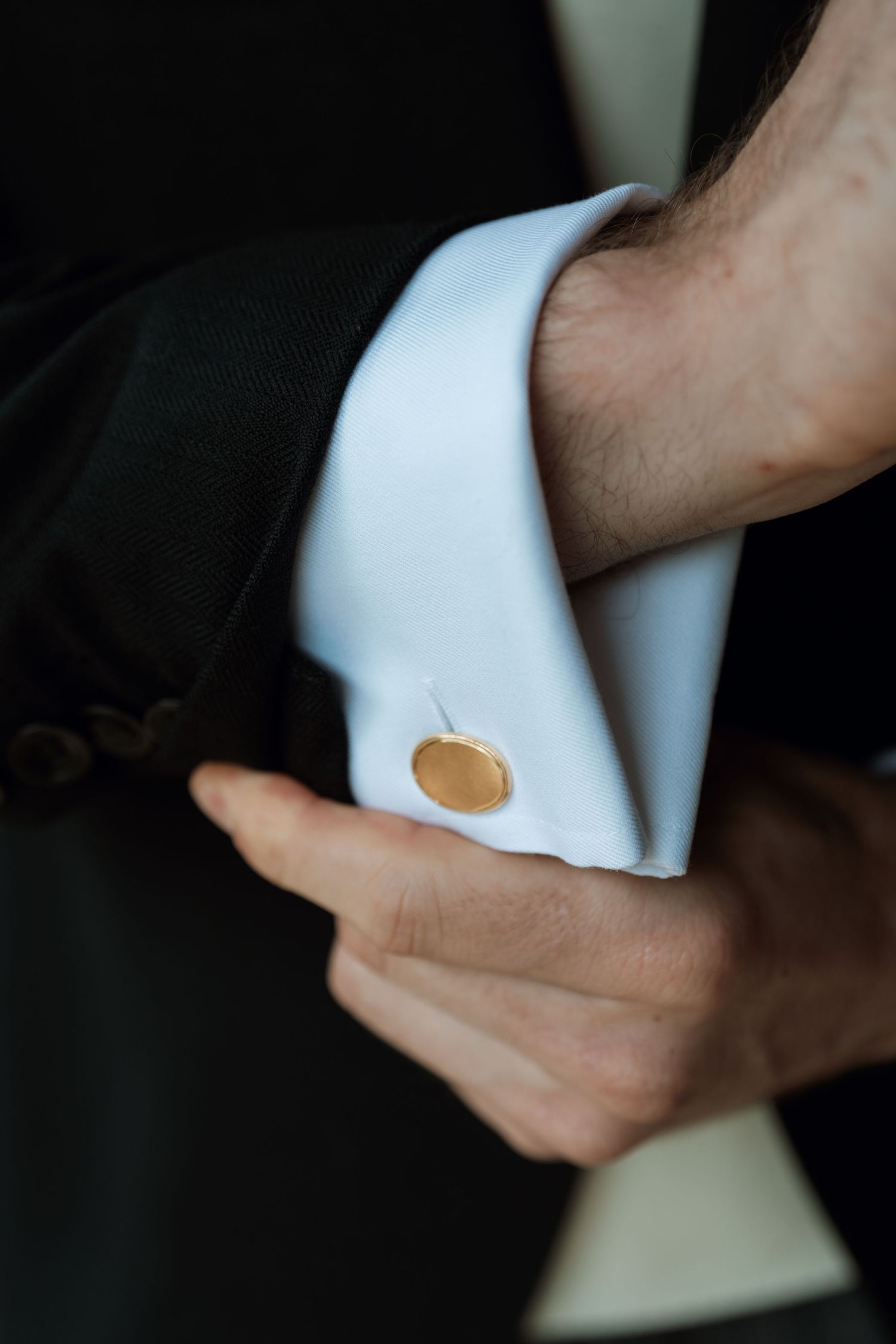 A sequence showing hands removing finger holes from a wedding ring, symbolizing a unique perspective on wedding details.