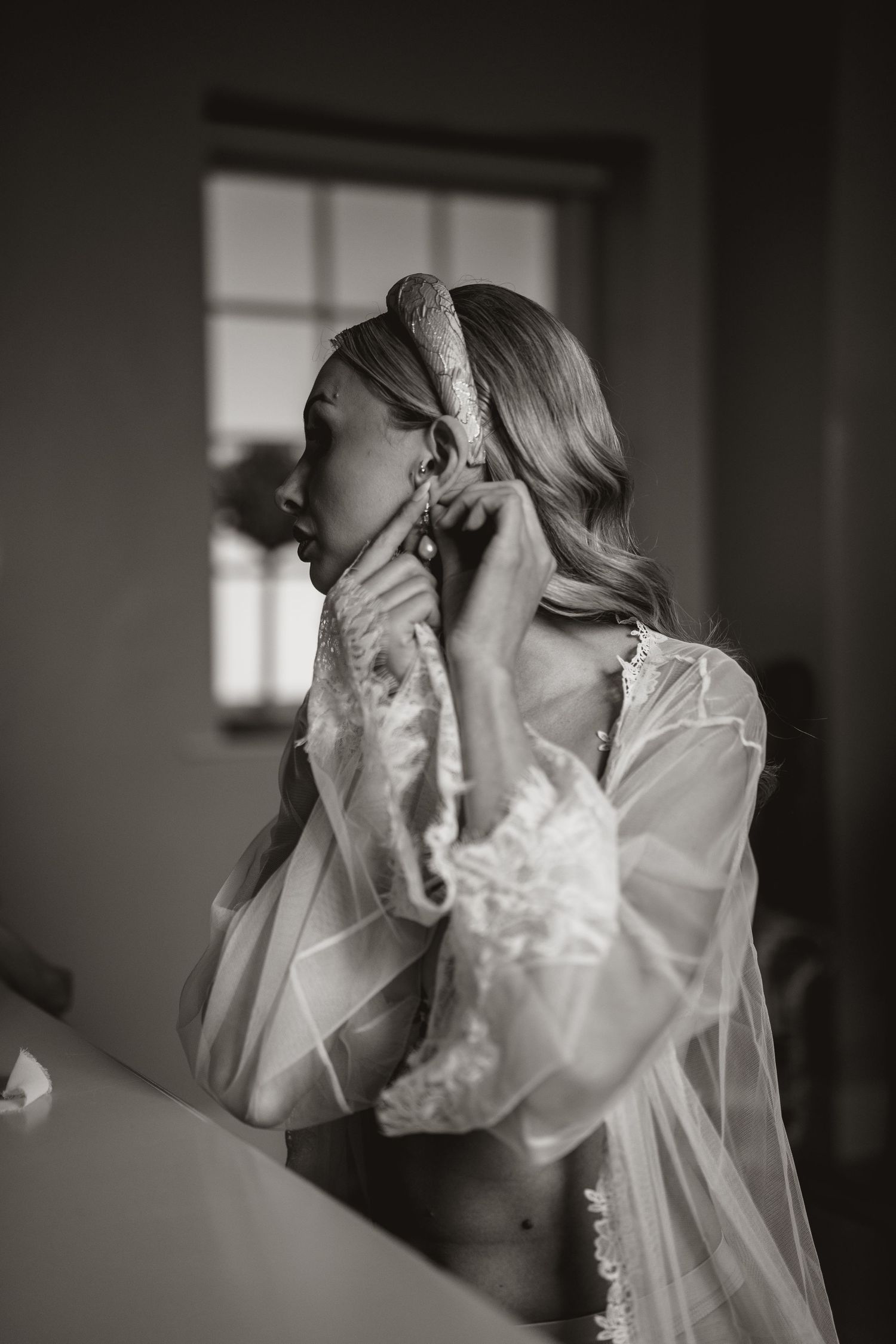 Artistic black and white boudoir photography featuring soft lace details.