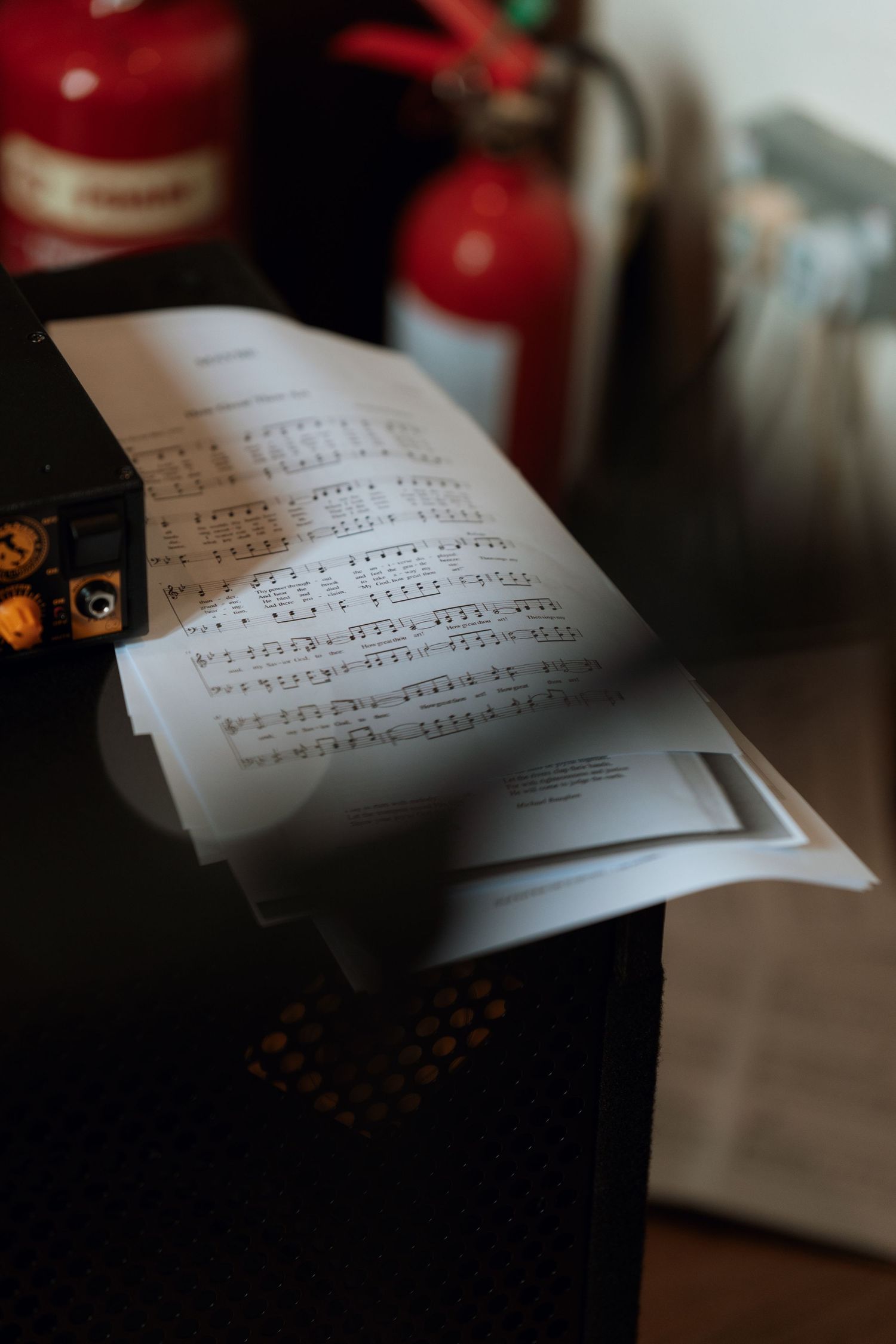 Sheet music pages displayed in soft focus with warm lighting.