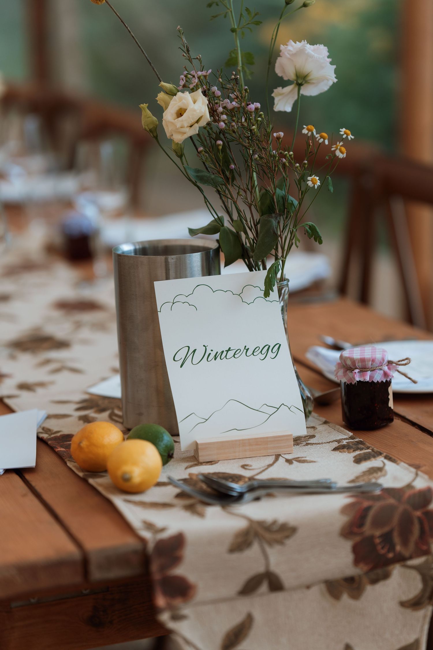 Wedding reception table setting with name cards and delicate floral centerpieces.