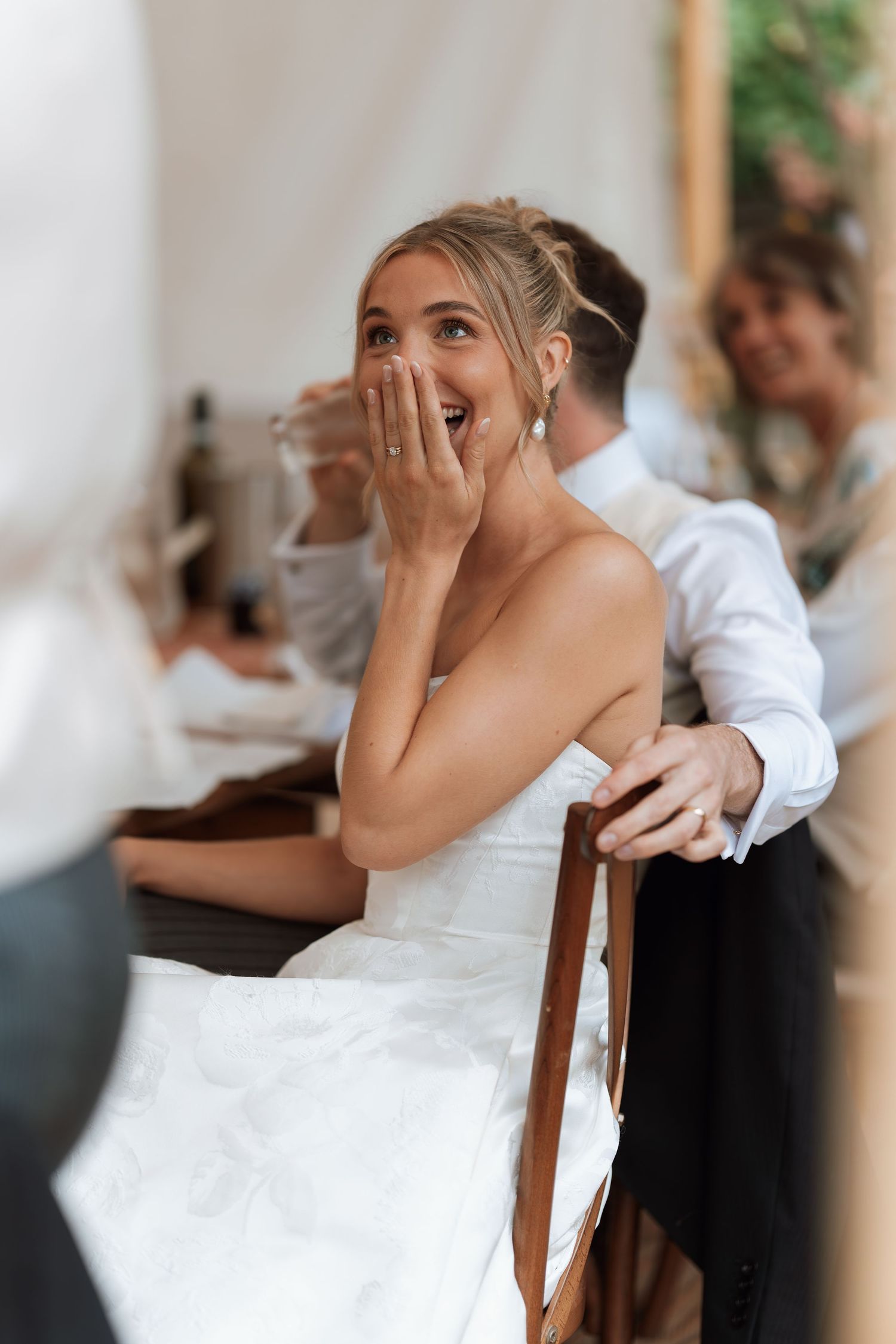 Emotional wedding candid showing a delighted reaction during the reception celebrations.
