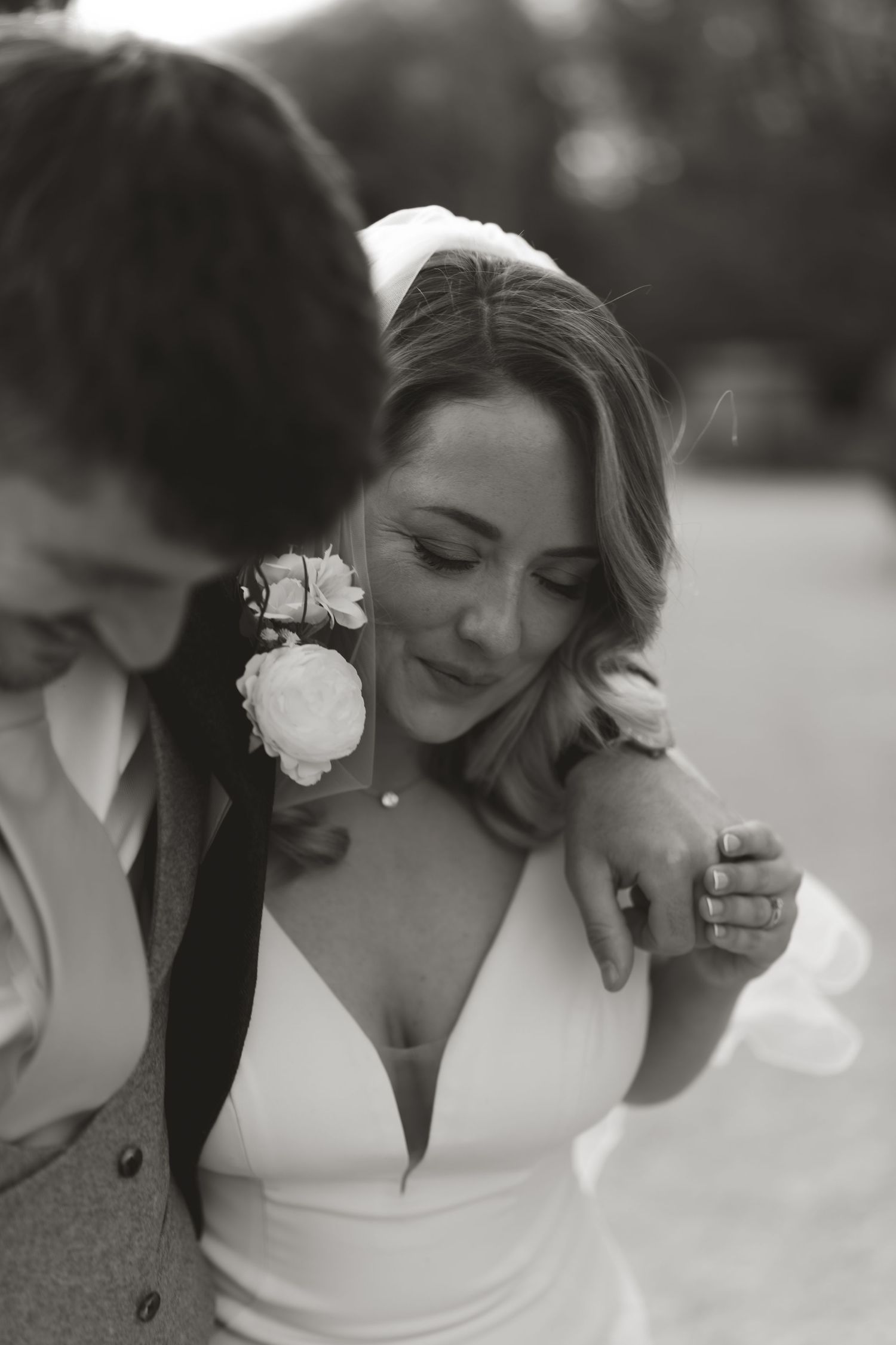 Intimate black and white wedding portrait showing tender moments between a couple.
