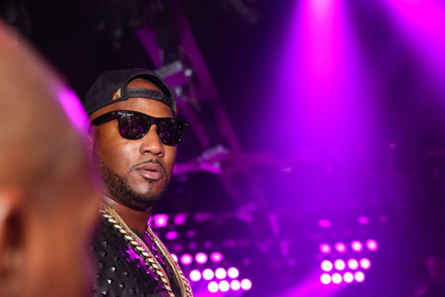 Jeezy at concert with purple lighting effects.