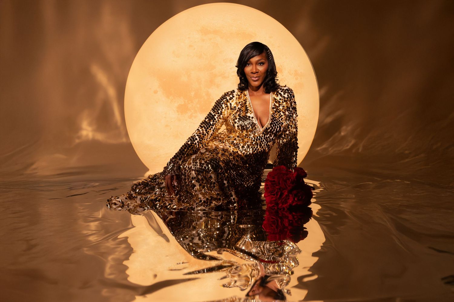Artistic portrait with a full moon backdrop and flowing patterned dress creating a mystical atmosphere.