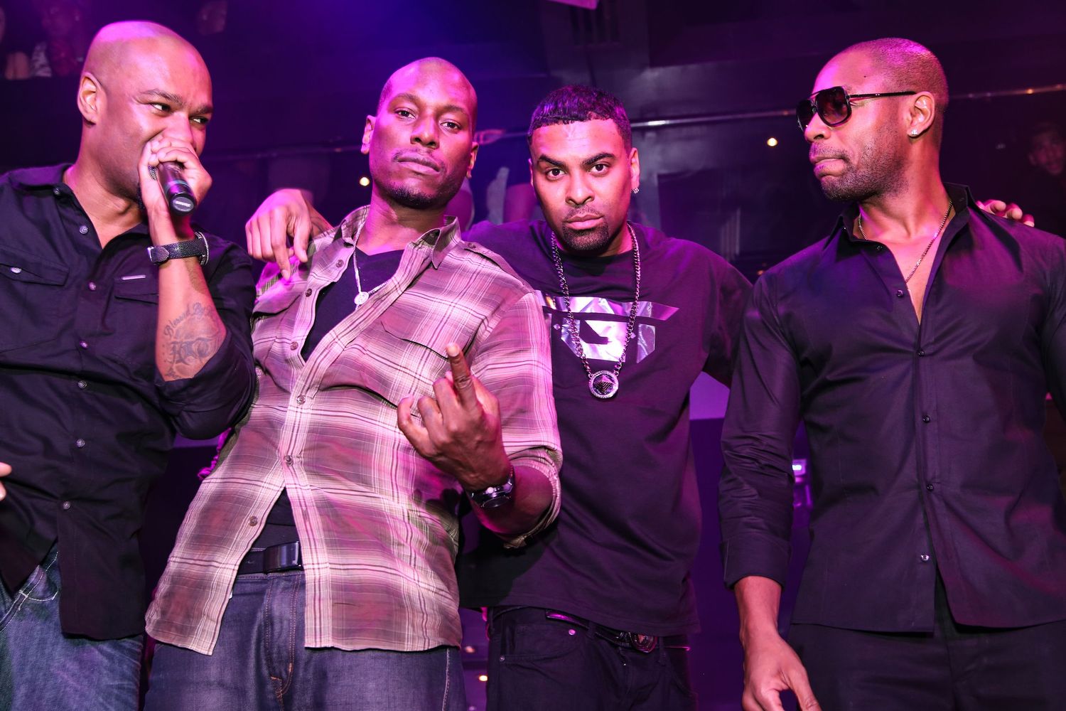 TGT Tank Genuwine Tyrese on stage at nightclub event.