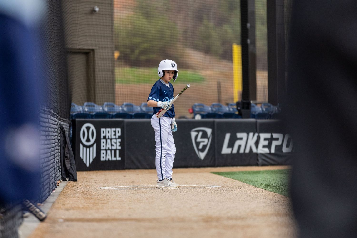 Baseball player stands in batting position at Lakewood field.