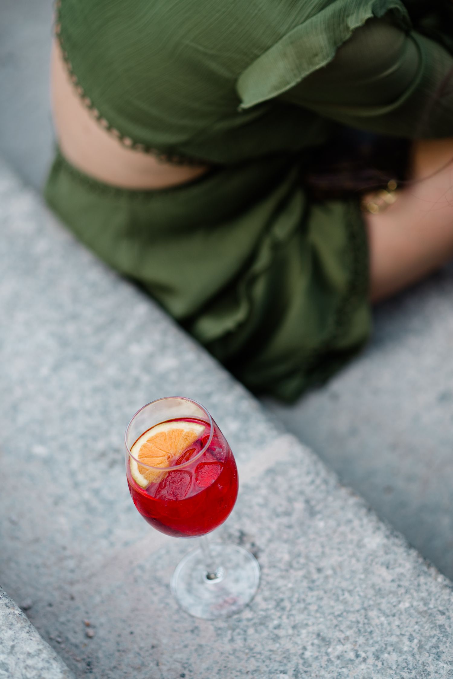 Wedding guest with a red drink