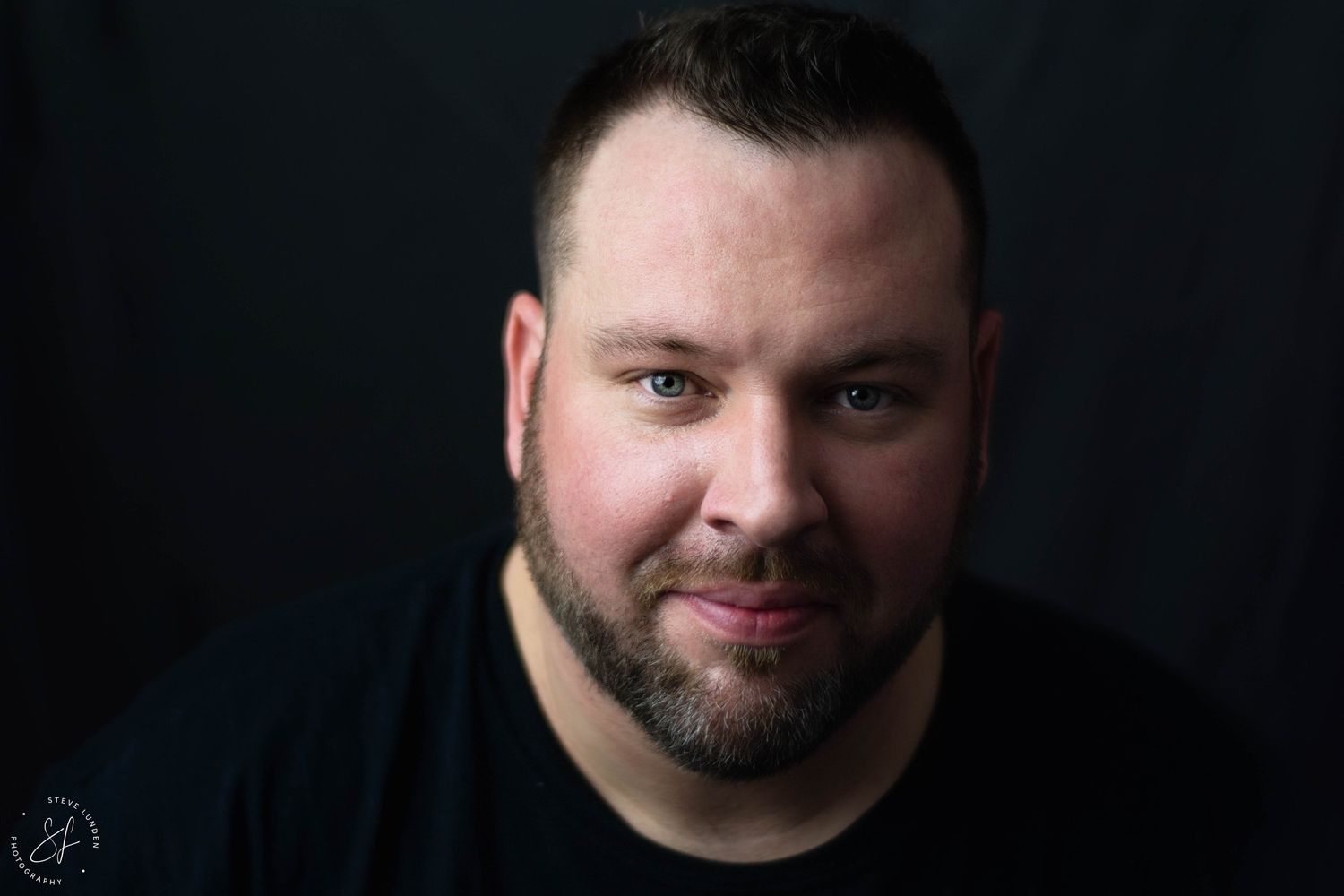 man posing in a rembrandt style portrait