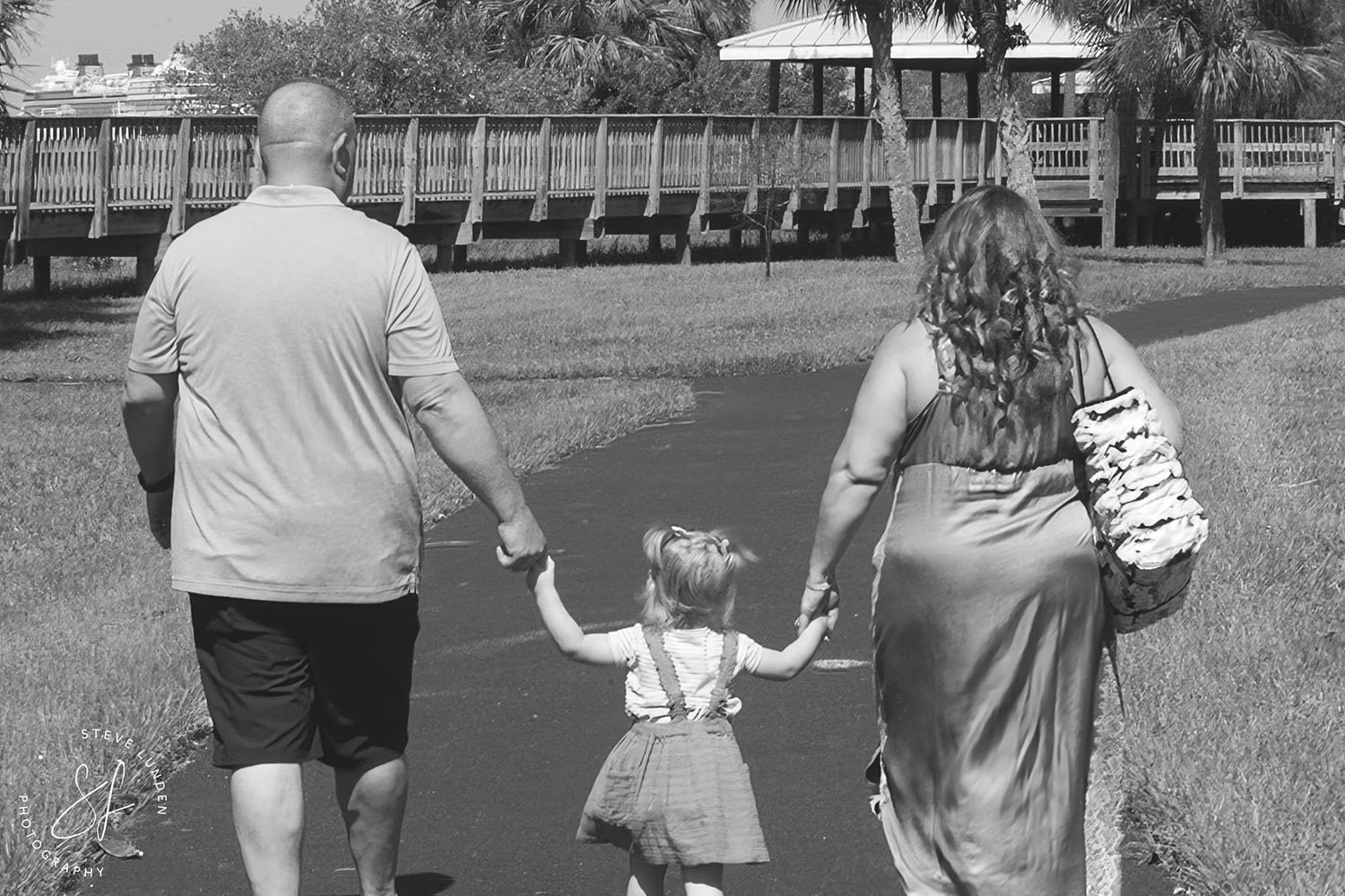 couple walking with toddler girl