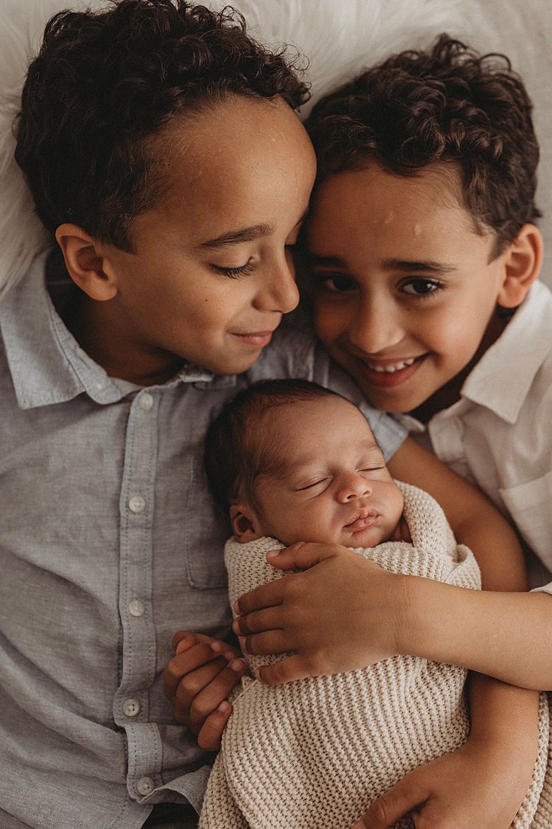 newborn photography sibling photoshoot geelong photographer studio big brothers holding new baby