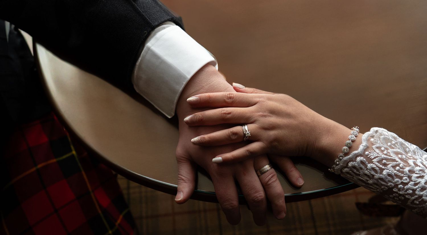 An assortment of hands visible in wedding photos showing rings and intimate gestures between a couple.