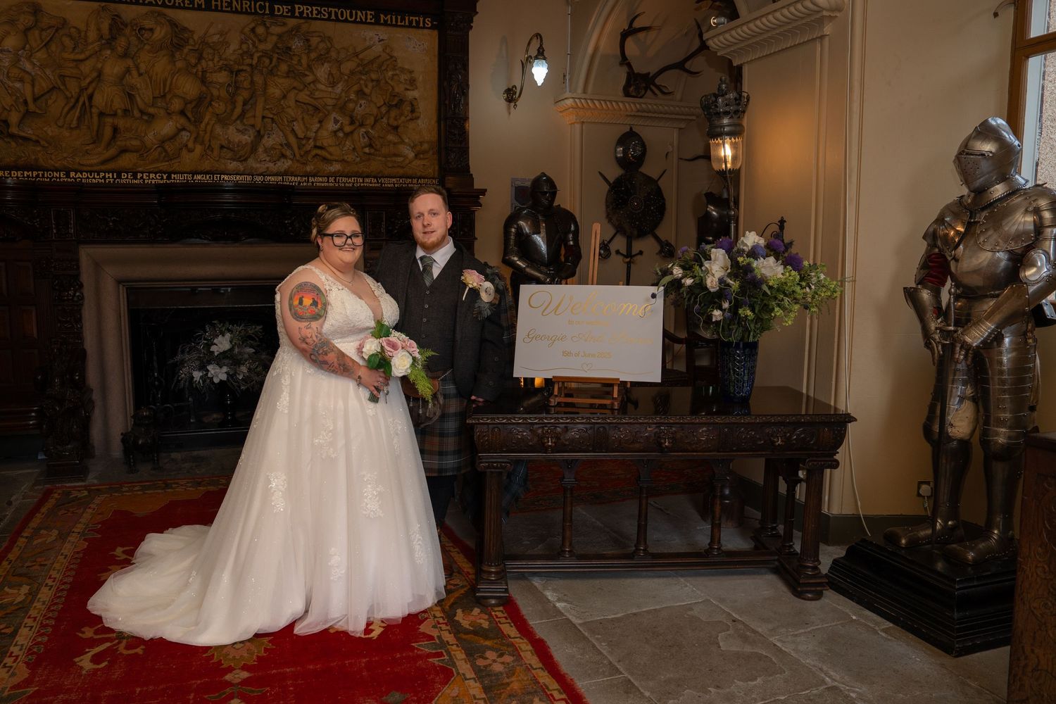 Wedding celebration in a rustic ballroom with ornate wall decor and elegant chandeliers.