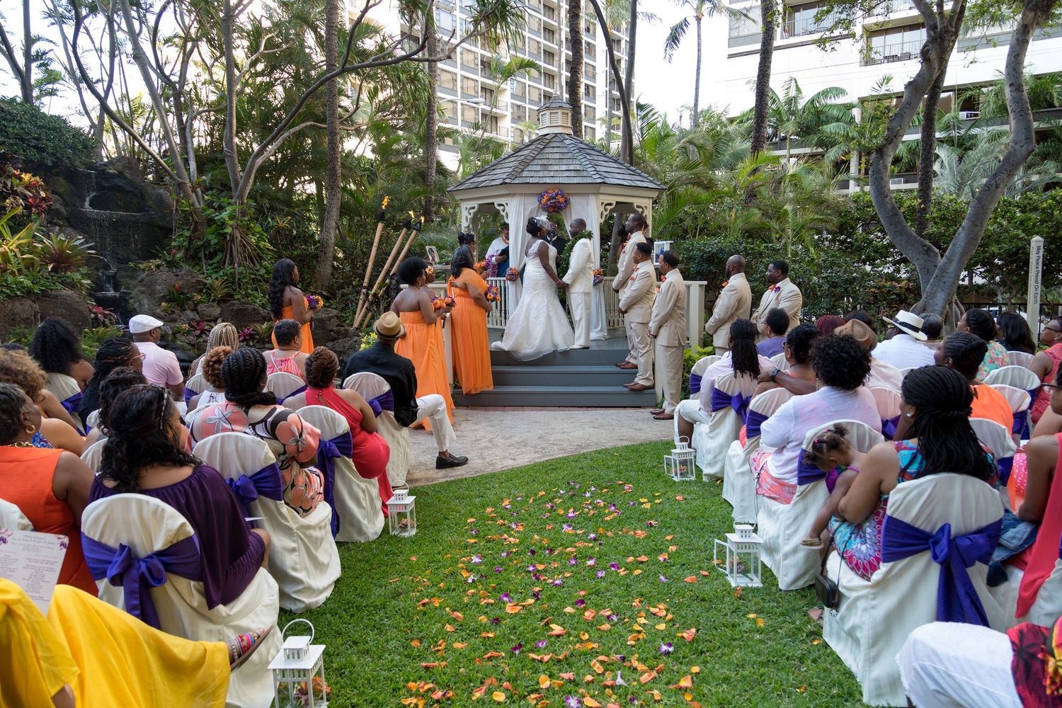 A wedding ceremony in a lush garden at the Hilton Hawaiian Beach hotel in Waikiki, Honolulu, Hawaii.