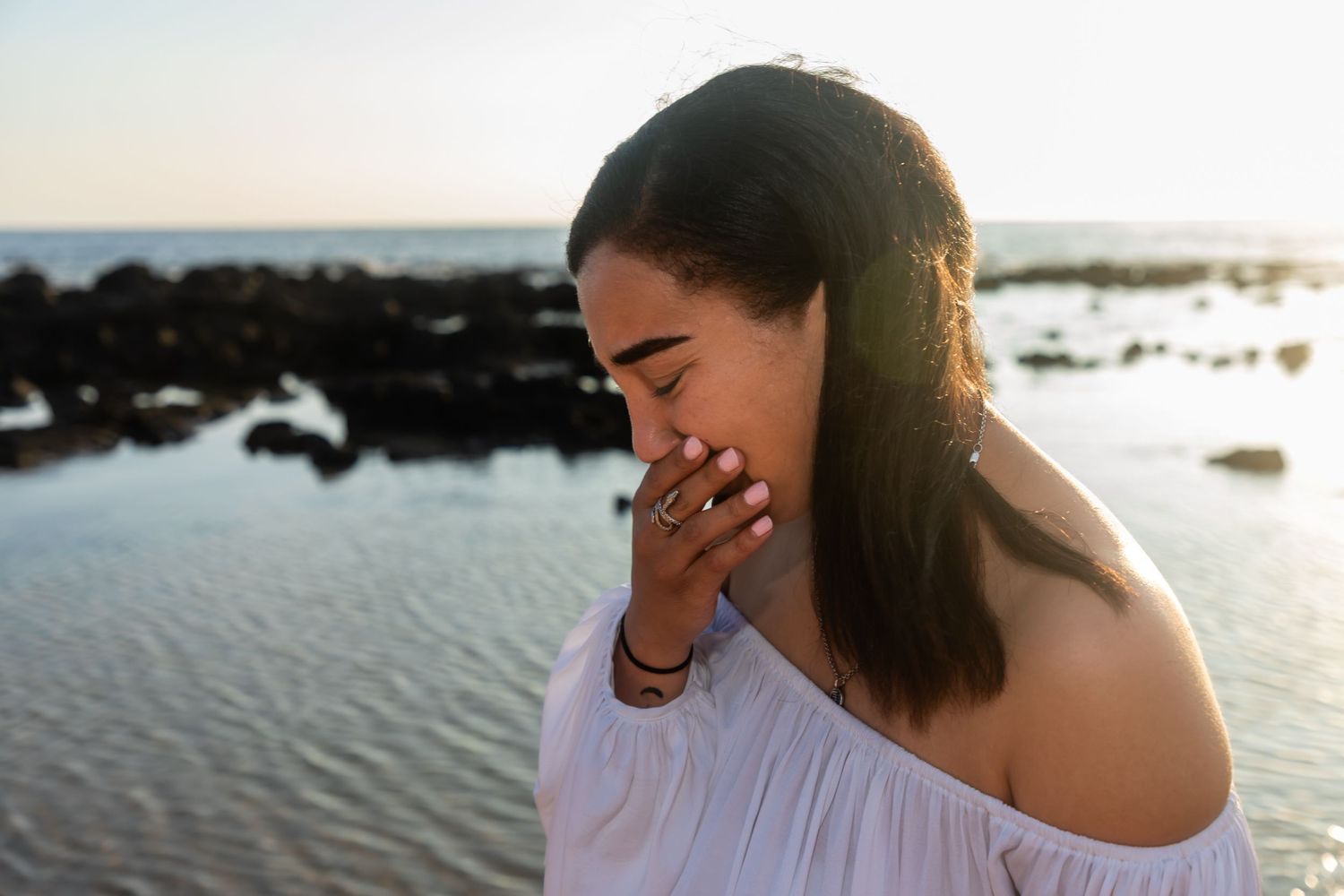Girl showing emotion after a surtprise proposal at the Old Airport Beach Park in Kailua Kona, Hawaii.