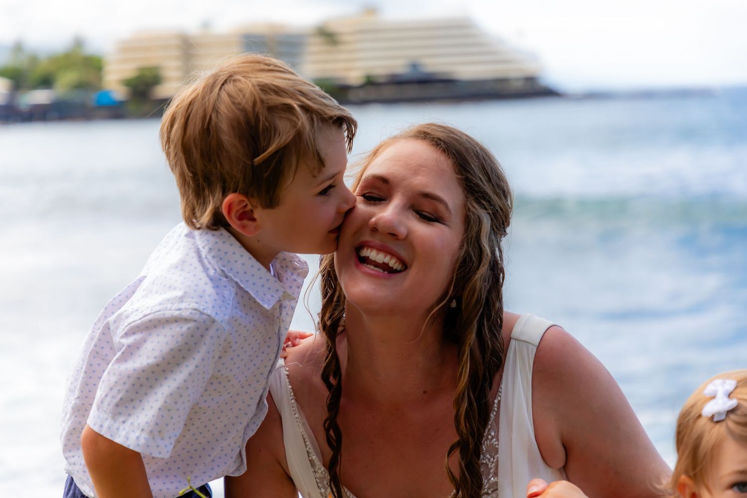 Joyful beachside wedding moment with cruise ship visible in background at Papa Kona in the Big sdland.