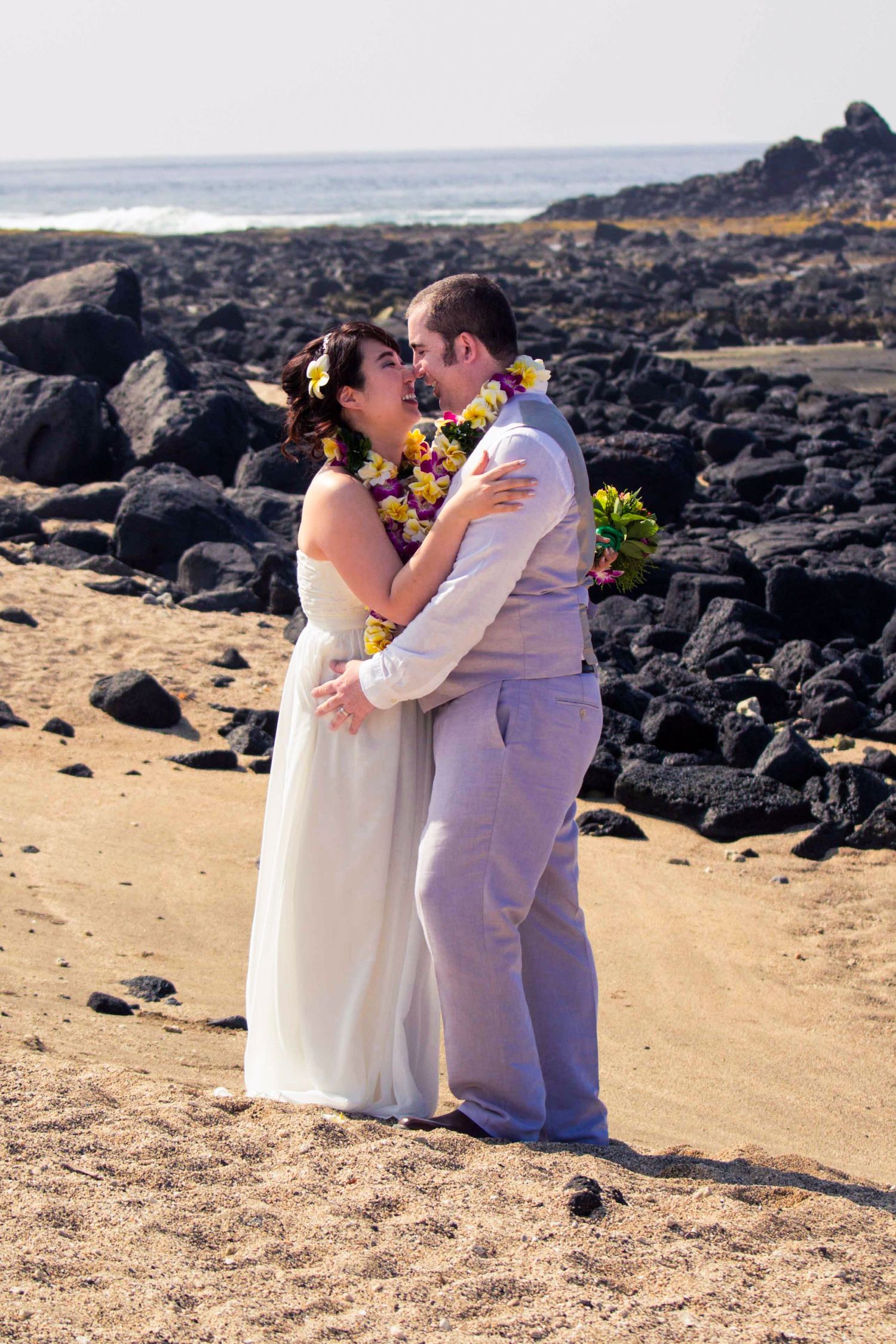 A couple shares an intimate moment on the Old Airport Beach Park in Kailua-Kona, Hawaii.