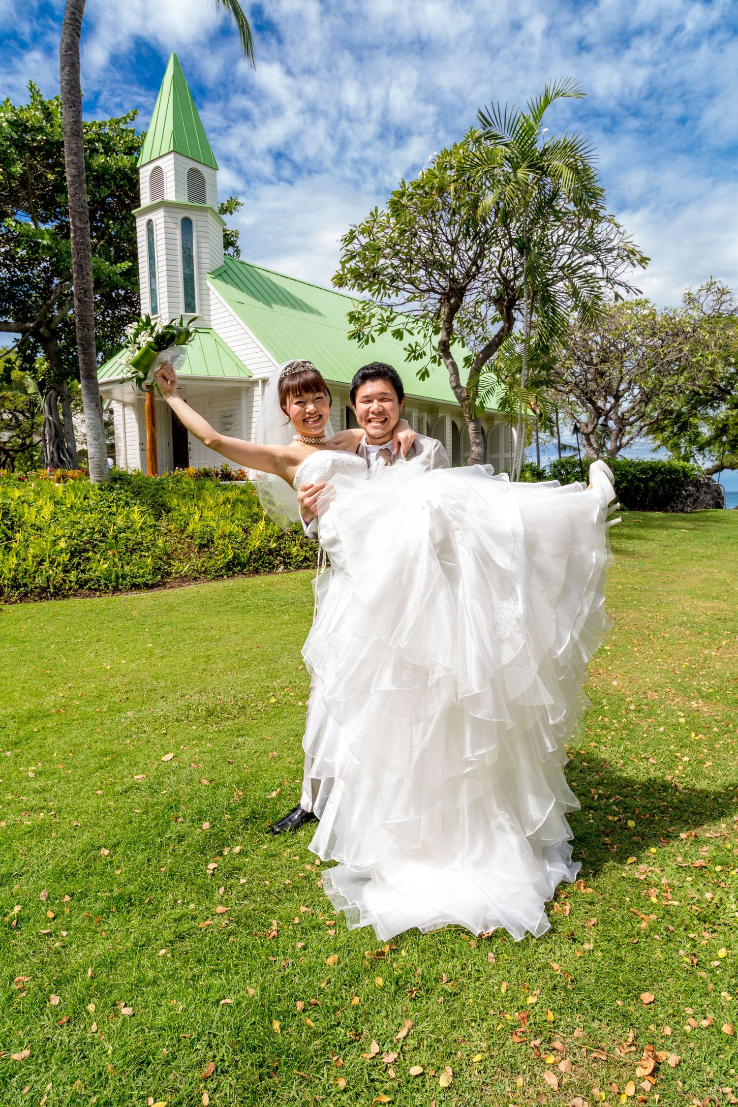 A Japanese wedding couple in front of the seaside chapel at the Outrigger Kona Resort & Spa hotel in Kailua-Kona, Hawaii
