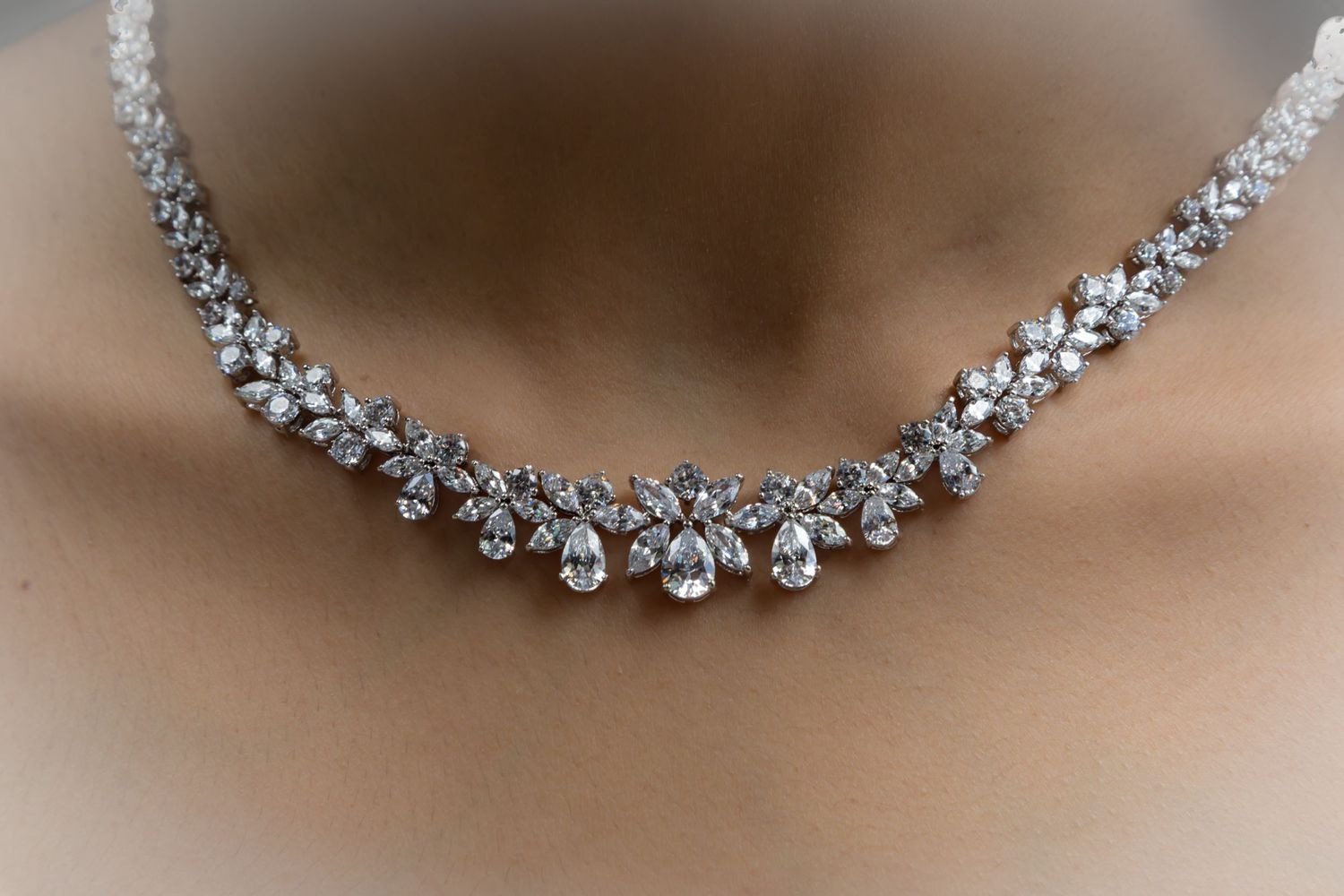Sparkling diamond necklace with delicate floral design on a bride's neck in Kona.