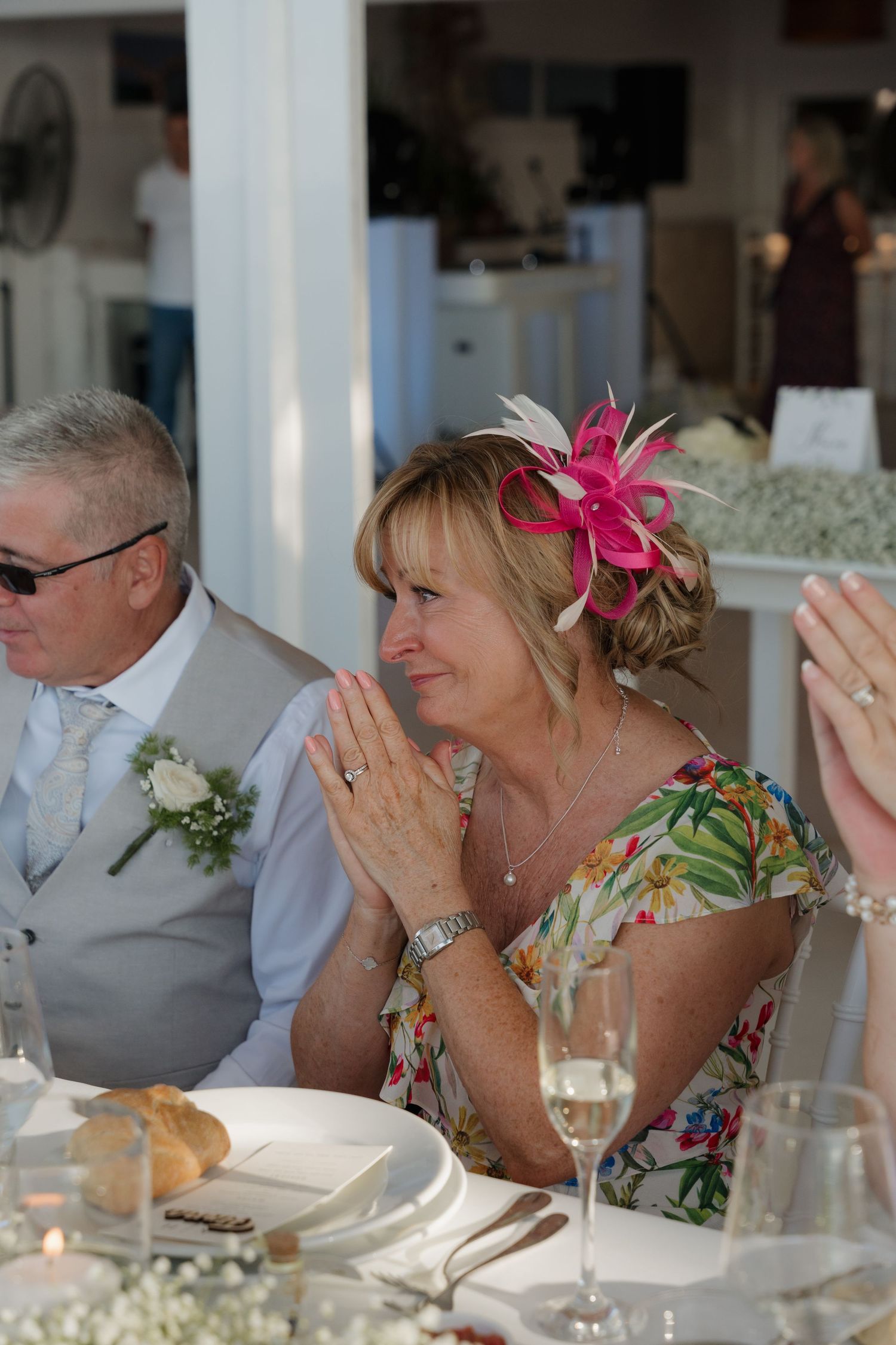 Reception guests enjoy emotional moment during wedding celebration at seaside venue.