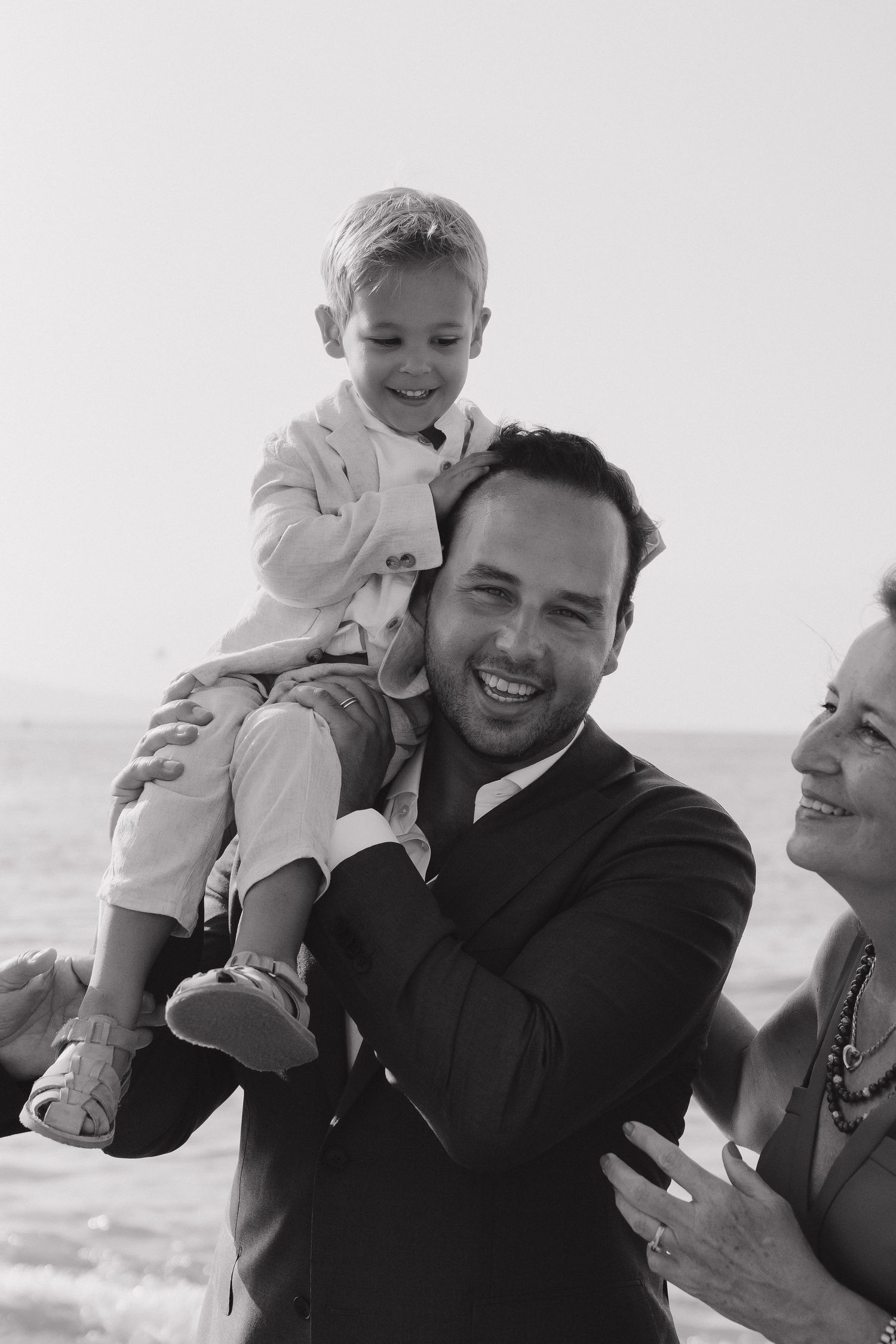 A joyful moment captured at an outdoor beach celebration.