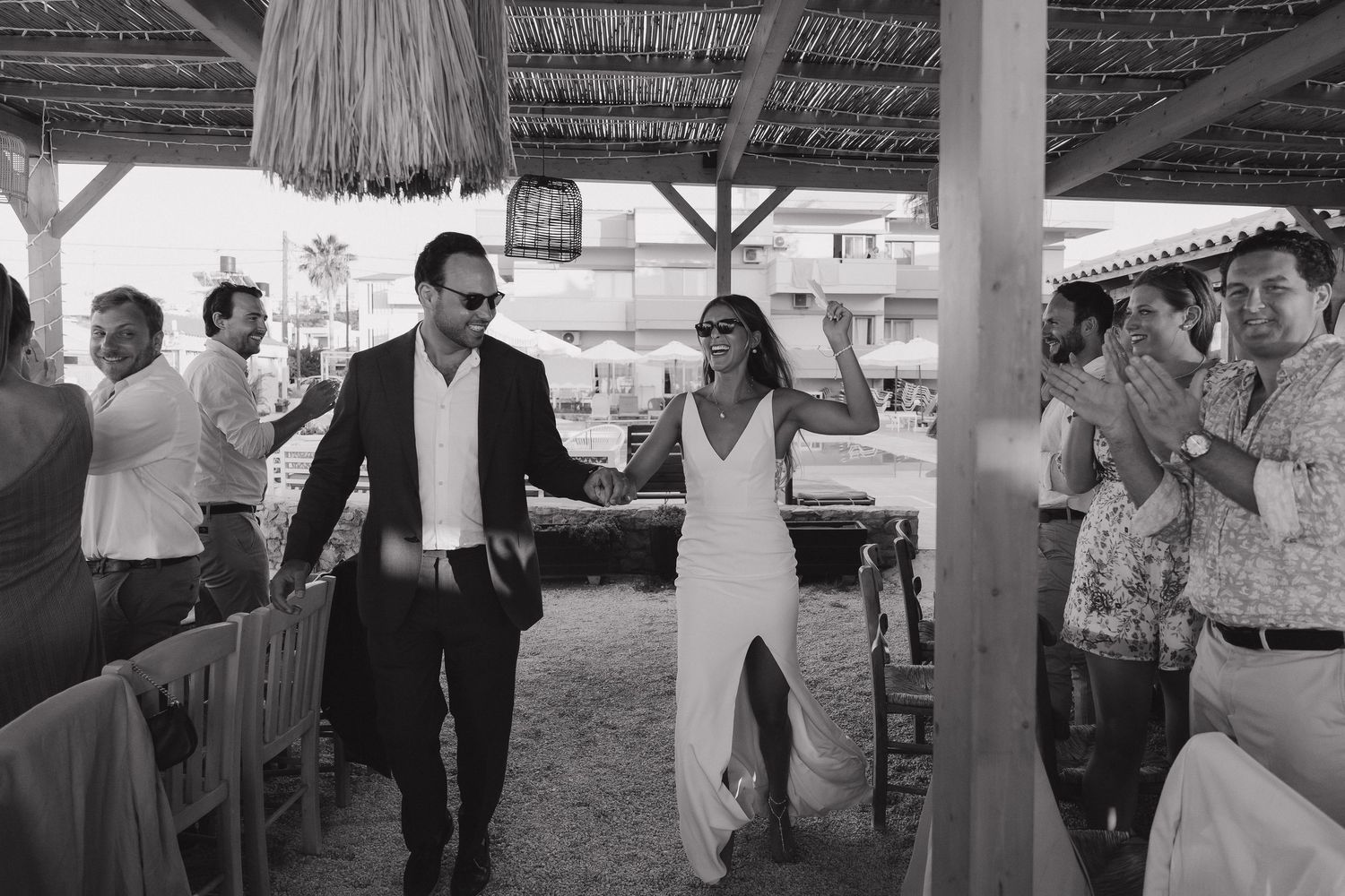 Wedding celebration under a covered outdoor area with string lights.