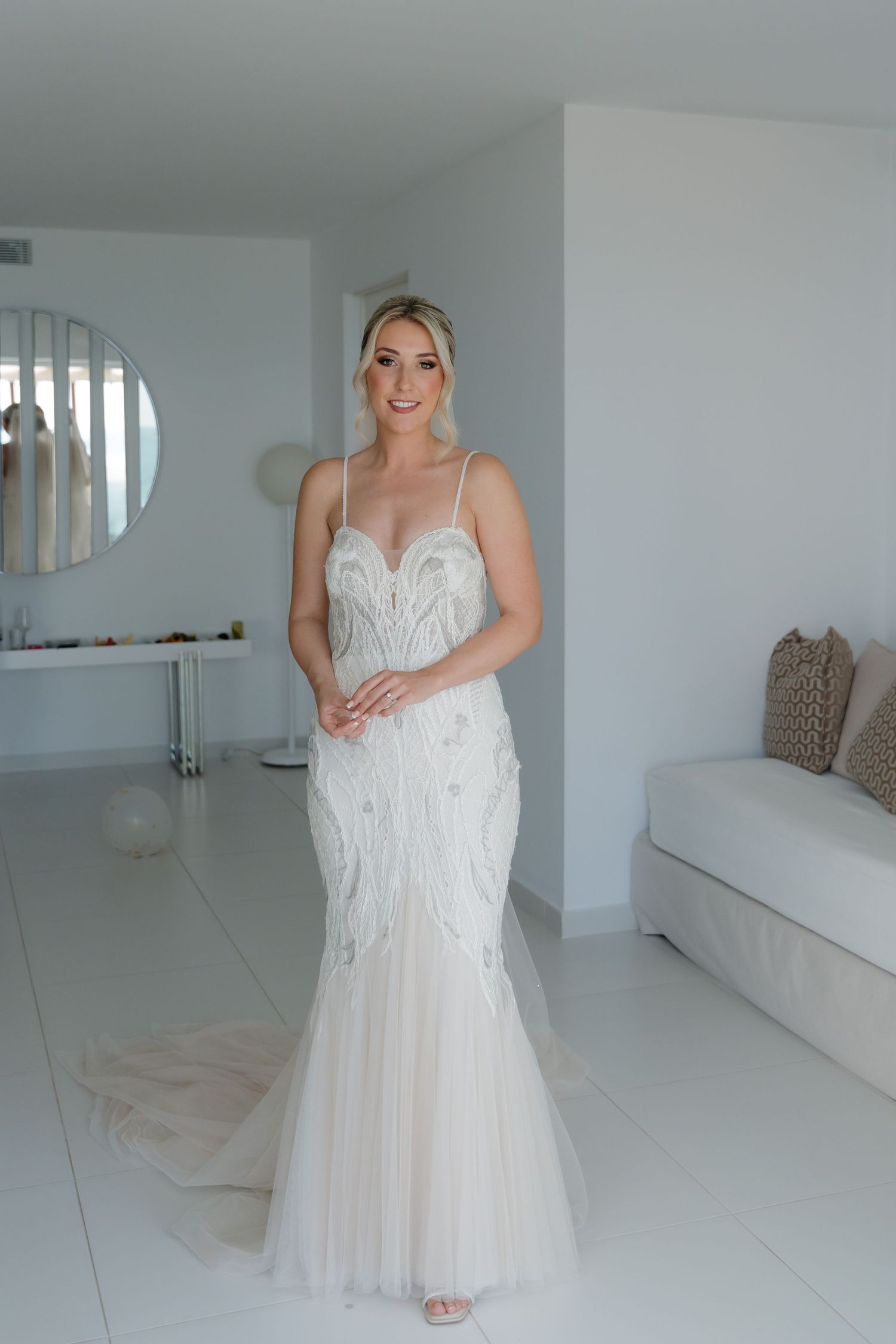 Stunning white mermaid wedding gown with delicate beading and tulle details.