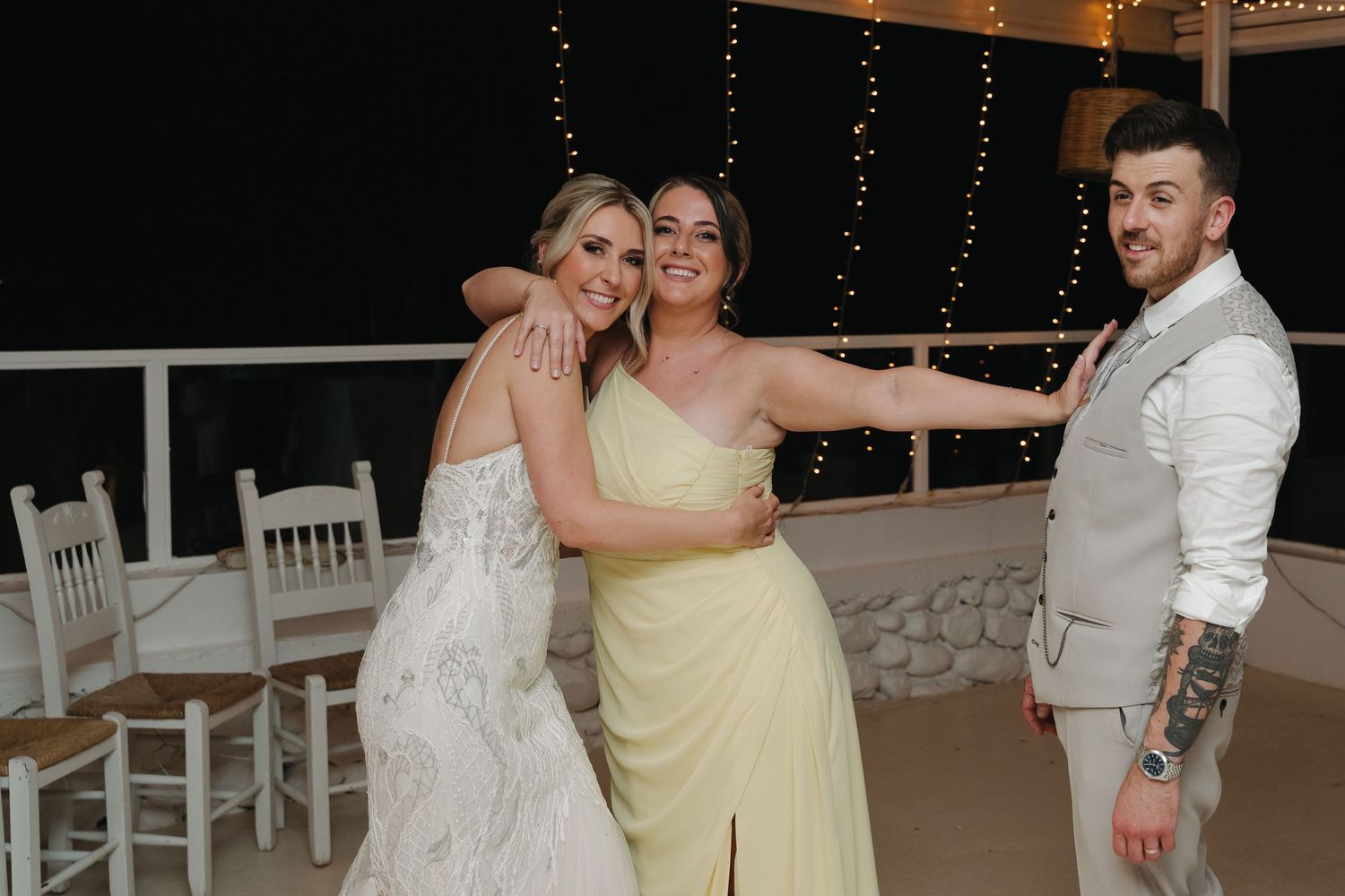 Wedding celebration with festive dance moves under string lights at night.