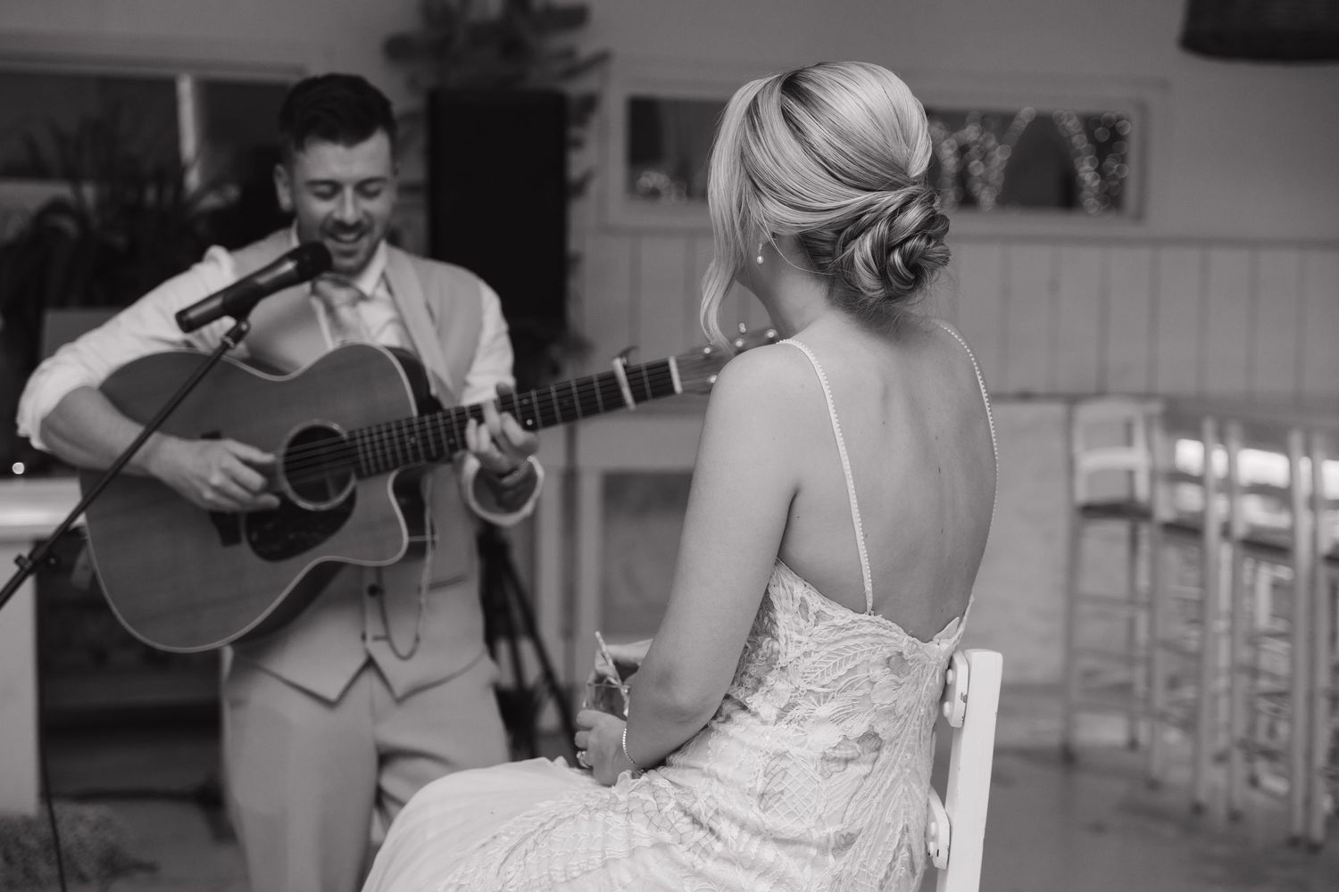 Live music performance and dancing at intimate wedding reception.