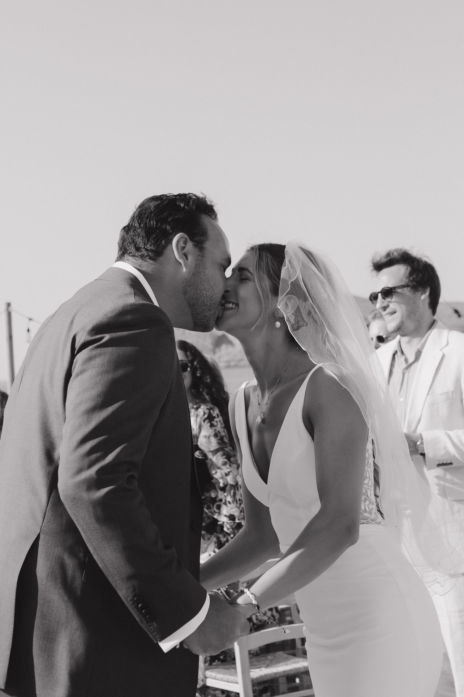 Series of intimate black and white wedding kiss photos showing romantic moments between newlyweds.