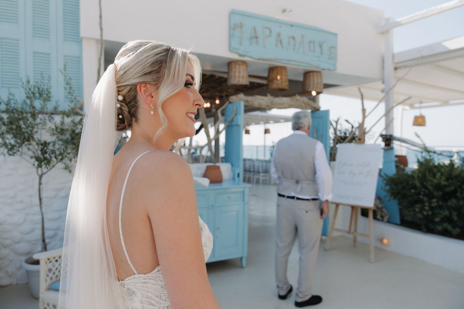 Seaside wedding venue with turquoise signage and coastal decor.