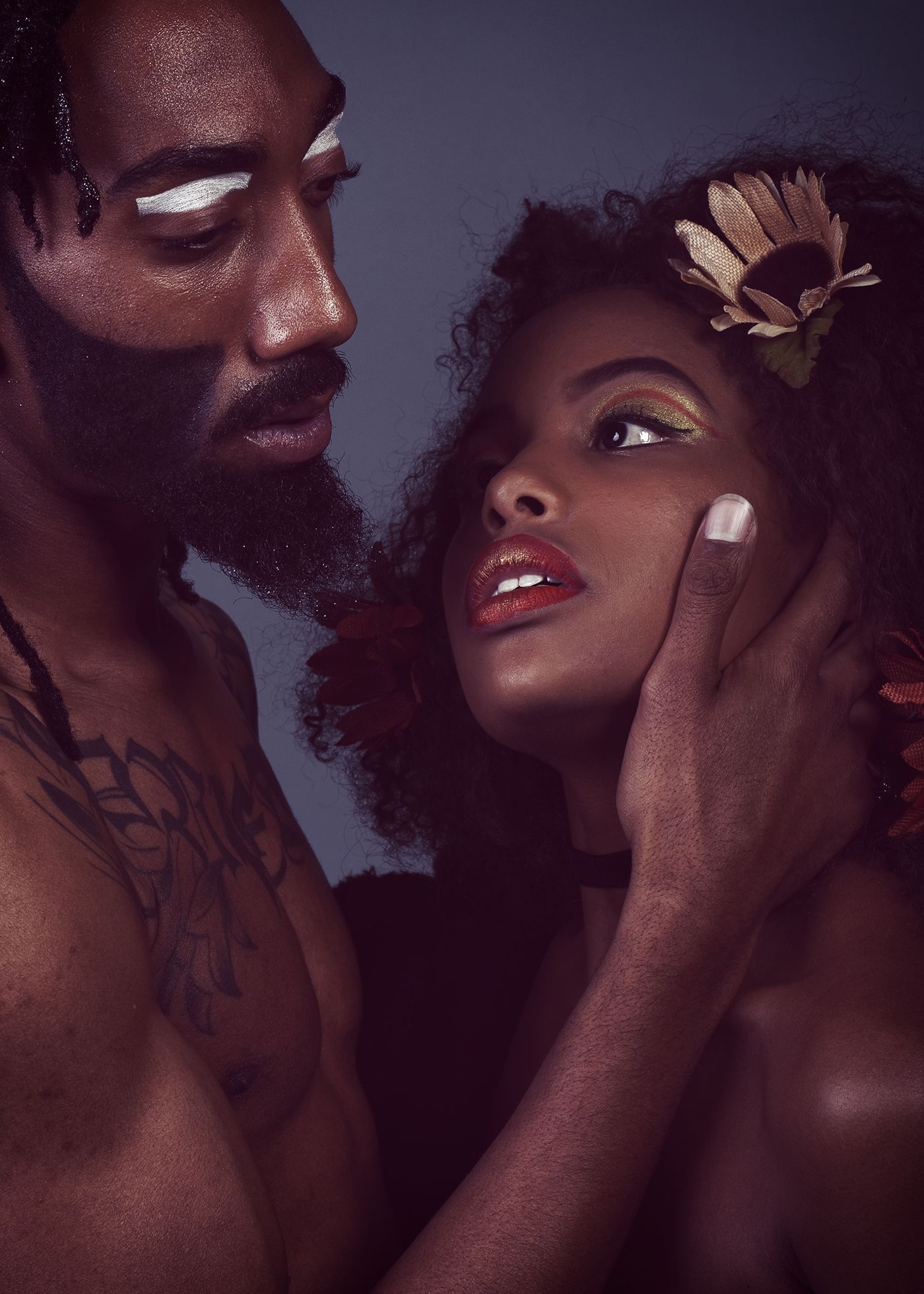 Artistic beauty portrait showing black couple in dark setting with atmospheric lighting . Fine Art portrait denver