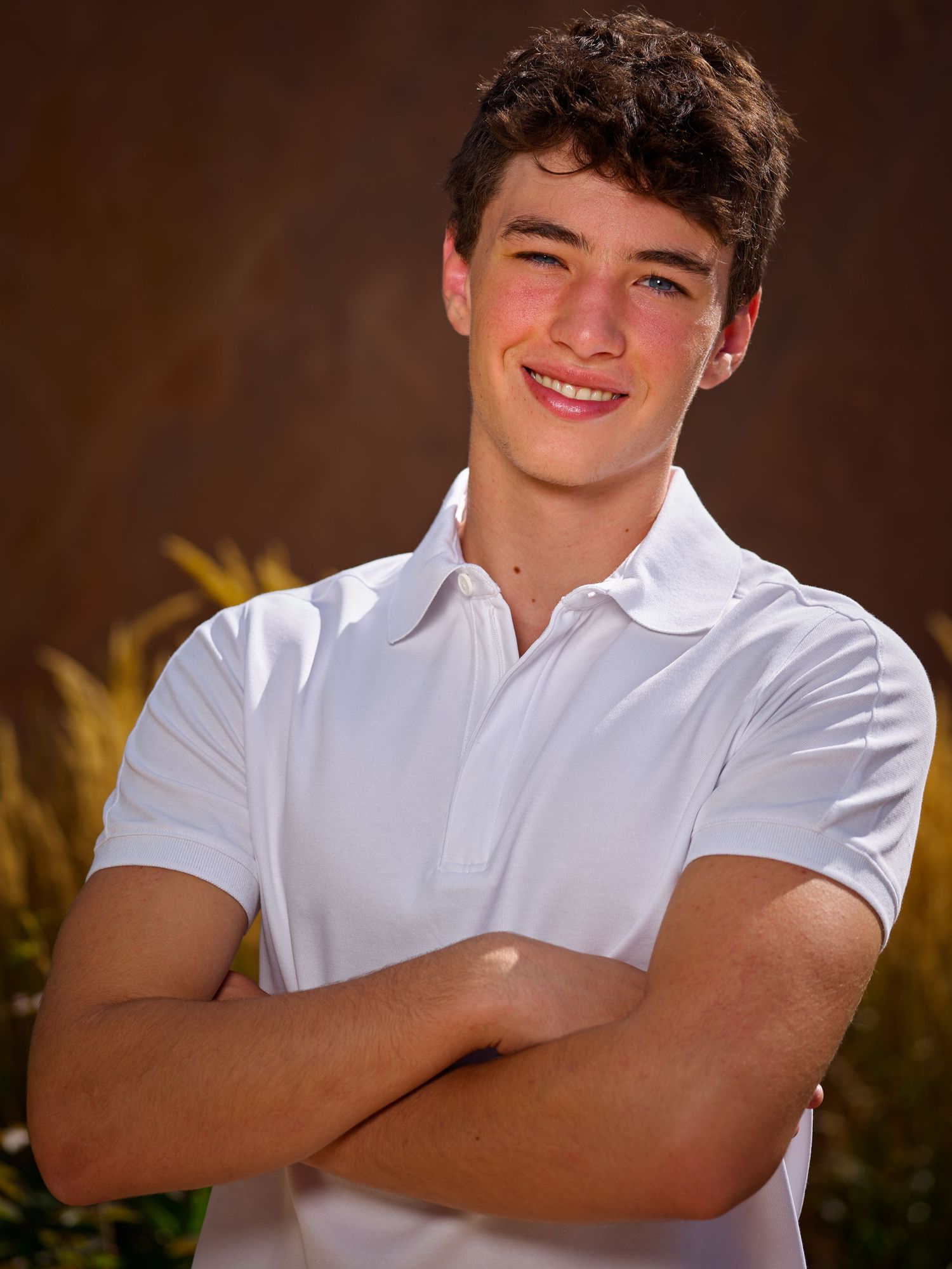 Outdoor senior portrait of a young man in white polo, Denver