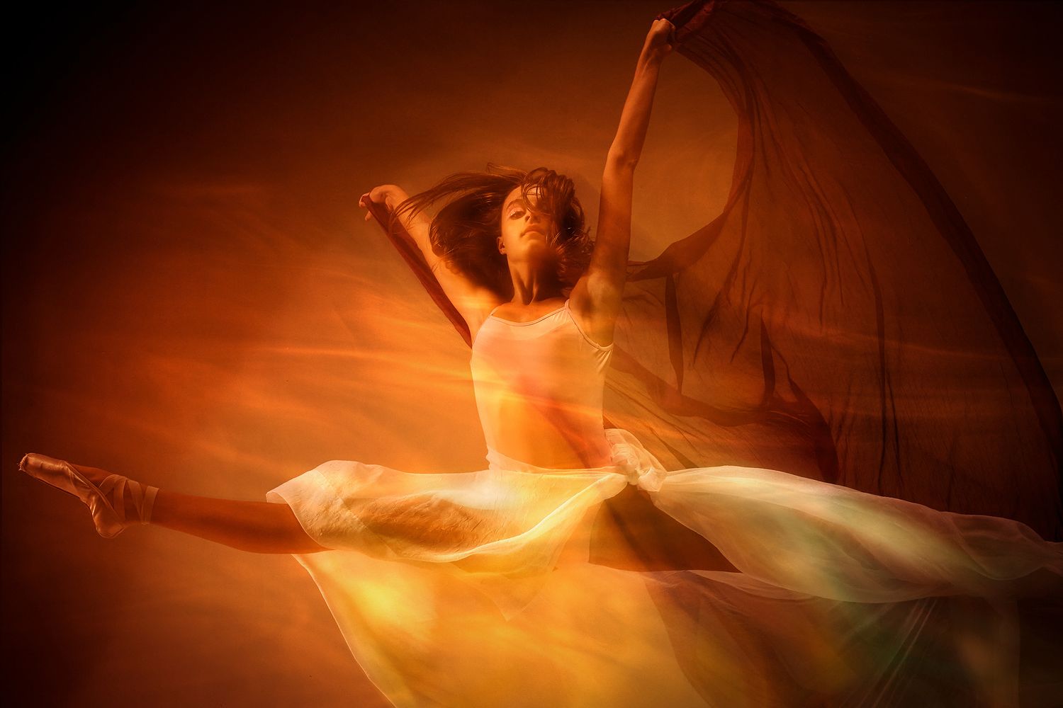 Long exposure photograph capturing dance movements with warm orange lighting and motion blur effects creating ethereal patterns.
