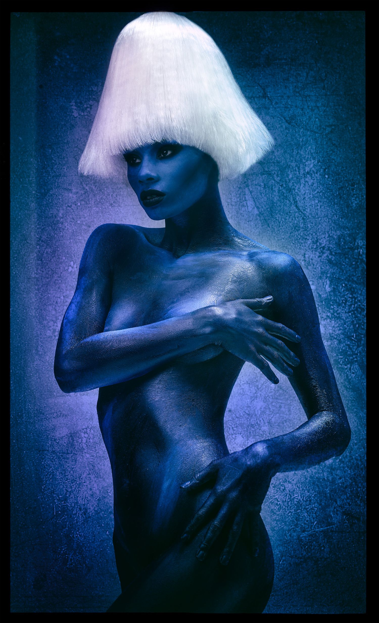 Artistic portrait series in blue tones showing a figure in white wig against dark background.